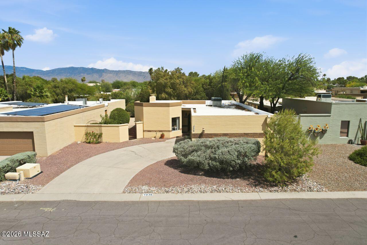 Fountain Park retreat! This Classic ranch has been beautifully maintained and updated with  a contemporary flair boasting a neutral color palette, new lighting fixtures, & hardware; added to the existing updated kitchen, baths & tile flooring inviting you to move right in.  The open-spacious floor plan is light and bright.  Beehive fireplace anchors the living room/ dining area creating the perfect gathering space. The expansive back yard features spacious covered patio and multiple brick paver opportunities for alfresco dining and entertaining. The Gardener will love the raised flower beds. This well established community of Fountain Park offers to residence a 5 acre park, play ground, pool & walking trails. Welcome Home! You'll never want to leave!