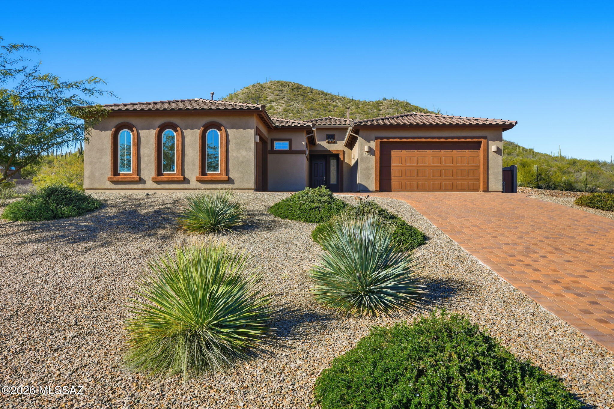 Rare opportunity in the Star Pass Vista gated community, where inventory is extremely limited. Set on an elevated 0.63-acre lot backing to a saguaro-studded hillside, this 2019-built residence offers exceptional privacy and mountain views. The Next-Gen-style layout features separate guest quarters ideal for multi-generational living, with a 2,270 sq ft main residence plus a 903 sq ft guest suite (2 bed / 1 bath), offering two distinct living spaces under one roof. Approximately 3,173 sq ft total, 5 bedrooms, 3.5 baths, a 3-car garage, and extended driveway. The expansive backyard offers space for a future pool and outdoor entertaining and is ready for a buyer to personalize. Homes in this private west Tucson community rarely come available.