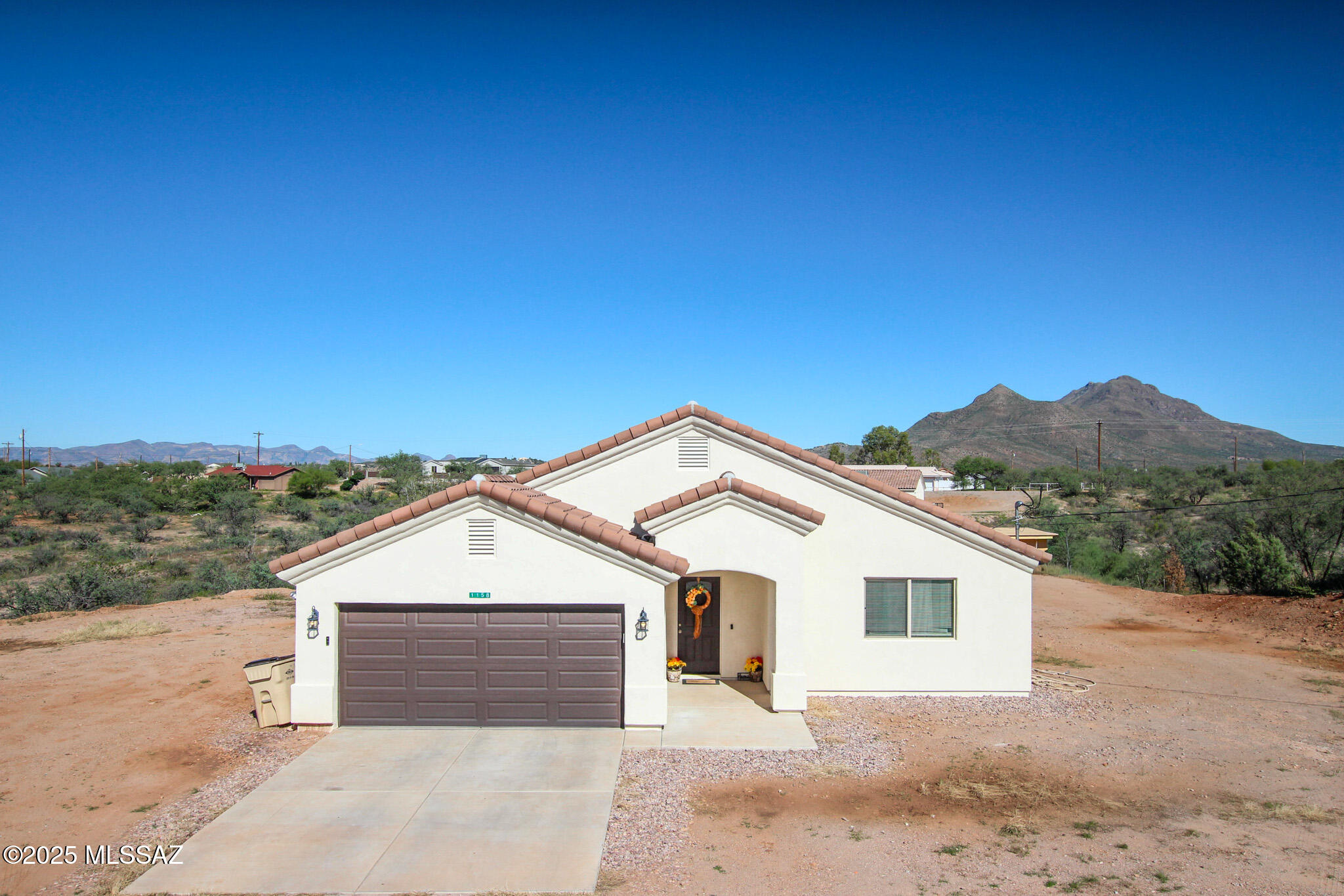 Beautiful well maintained 3 bedroom 2 bathroom home in relaxing Rio Rico, Home has custom stand up showers and no carpet anywhere! Kitchen is convenitntly hidden behind the living room giving privacy while cooking. As you look out the window from dining area and primary bedroom window you will glance at those breathtaking mountains. Home comes with a huge lot with the majority of usable land. Call today lets make this home yours!