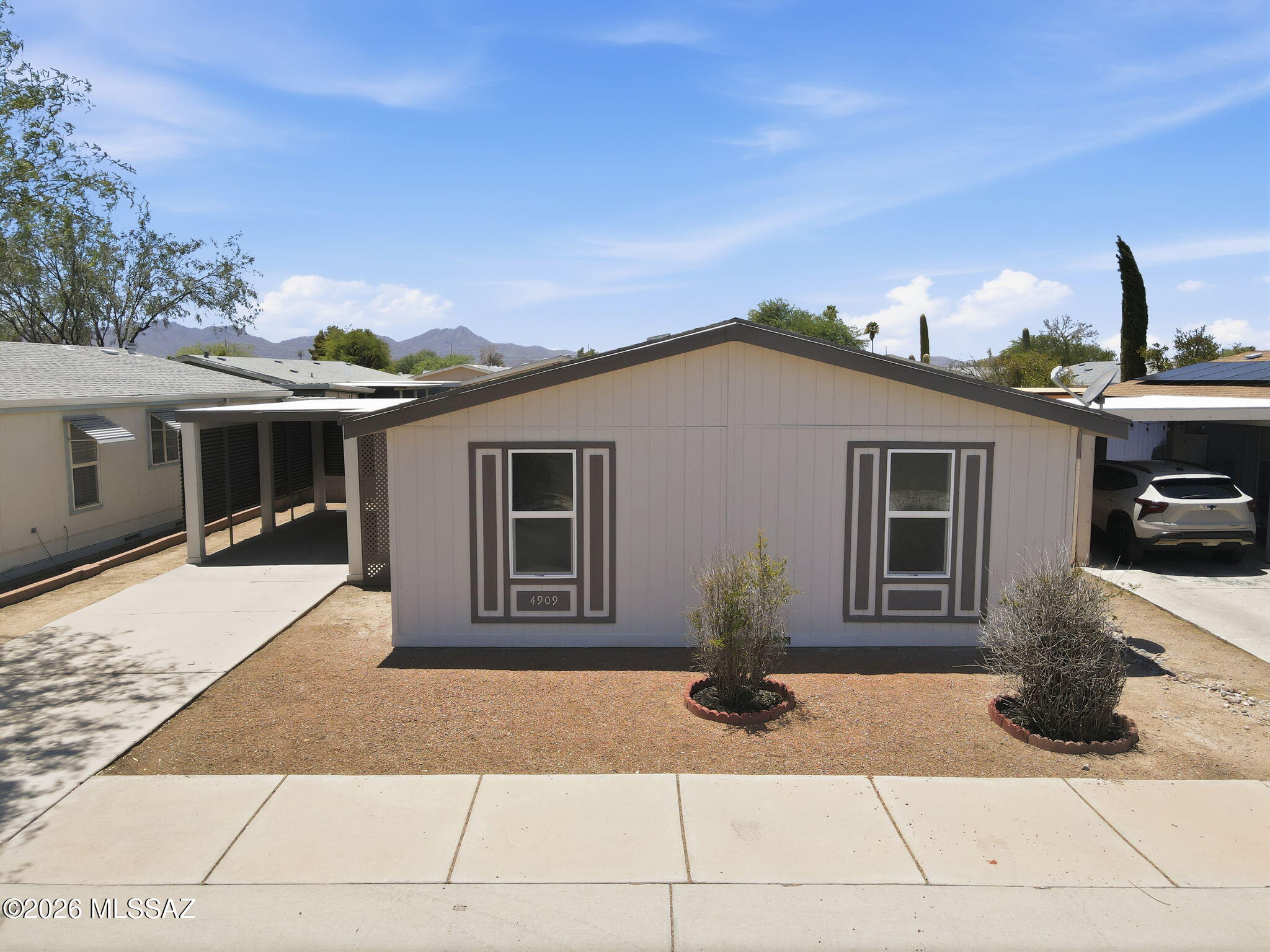 Affordable, updated, desirable ground set manufactured home in nice community River Point.  Great location with community flanking the Rillito River Park and has gate access to THE LOOP.  Neat and clean home and yard with new wood look plant LVP throughout (no carpet), split bedroom floorplan and open living concept.   Island kitchen is bright and airy with marble look tile countertops and new stainless steel appliances.  Dining space right off the kitchen. New ceiling fans throughout.  3 Nice size bedrooms, 2 updated bathrooms with new vanities, faucets, lights and fixtures.  Super clean and move in ready!  Good size fully fenced backyard with block wall and storage shed in place. Parking for 2 vehicles, one under the carport., which also is a shady area at the entry door.   Easy access to shopping, services and also good I-10 access, just a few minutes away.
