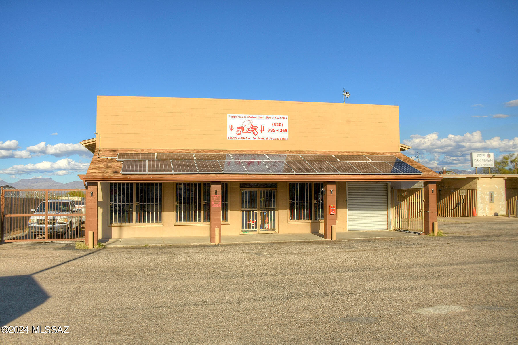 Outstanding opportunity with this spacious 5000 Sq ft building on a 1/3 of an acre w/shared and fenced parking. Featuring over 720 ft of Retail/office space at the front of the building, Loft office and 4300 Sq ft of warehouse/workshop space with 15 ft ceilings. Roll up garage door allows access to a spacious work area unimpeded by walls or barriers. Electric equipped with 220 for vehicle lift, large compressor or welding. 14.3 kw of owned solar provides ample power for the building. Bath is large enough to add a shower and additional storage space in the loft above. Tired of paying high rents? This property is a blank canvas awaiting your creativity. NOTE: Owner financing available at 6.5% with a 5 year balloon & 20% down.