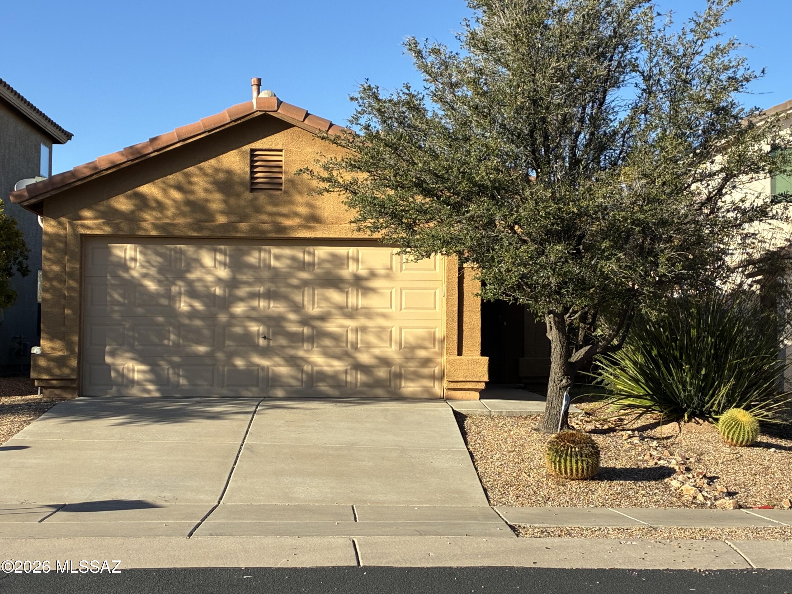 Wonderful 3BR, 2BA home with a sunny open floor plan with beautiful desert common area behind the backyard. The kitchen is upgraded with stainless steel range and designer tile backsplash. The home has ceramic tile and wood laminate throughout for easy cleaning. The garage floor has been newly coated and there is artificial grass in the backyard with a firepit area for fun evenings outside. This home is ready for it's new owners!