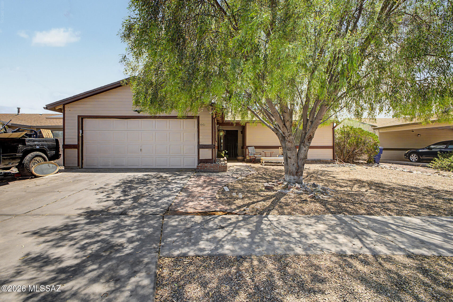 Seize the opportunity to own this charming 2-bedroom home with an inviting curb appeal, a mature landscape & a 2-car garage! Inside, the sizable living areas showcase wood-look floors, vaulted ceilings to enhance the space, plenty of natural light, a cozy fireplace, and a soothing palette that makes every space feel warm & welcoming. The well-appointed kitchen is complete with plentiful storage cabinetry, ample counter space, and built-in appliances. Enjoy a good night's rest in the primary bedroom, offering a full bathroom with double sinks for added convenience. Large laundry room with attached cabinetry and sink. Out back, you'll have a covered patio ideal for morning coffee, plenty of room for outdoor activities & a shed/workshop. What's not to love? Make it yours!