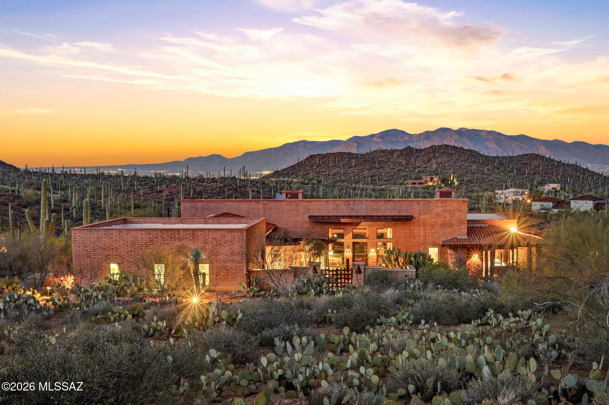 A truly one-of-a-kind desert oasis retreat nestled high in the Tucson Mountains on 10+ acres, just minutes from Saguaro National Park and Sweetwater Preserve. This custom-built estate offers approximately 3,700 sq ft of luxurious living space and showcases rare, artistic architecture, upgraded to absolute perfection. The main residence is a designer home that feels like a private resort, featuring serene waterfalls, a saltwater zero-edge PebbleTec pool designed to resemble a natural swimming hole, and a primary suite with its own private porch accessed by sliding doors. Thoughtful details include hand-milled cabinetry and doors, colored concrete floors and countertops, plaster walls, and three fireplaces, all blending seamlessly with the surrounding desert landscape. The main home also features a unique outdoor shower, enhancing the spa-like, resort experience. A secondary home provides a full bedroom, full bathroom, complete kitchen, and full-size laundry--ideal for extended family, guests, or investment opportunity--and includes its own outdoor shower for added comfort and convenience. Additionally, a bonus casita, converted from the garage, offers a full kitchen, laundry, and a private bedroom with a bath, enclosed by a 10-foot stucco wall for ultimate privacy. The estate welcomes you through an inviting courtyard entry with fountain ponds, while wraparound patios featuring Spanish roof tiles and red brick pavers create multiple spaces for relaxation and entertaining. Bathrooms are finished with travertine, limestone, and natural stone slabs, reinforcing the home's organic, luxurious feel. This is more than a property - it's a rare desert haven offering privacy, artistry, and resort-style living in one of Tucson's most breathtaking settings.