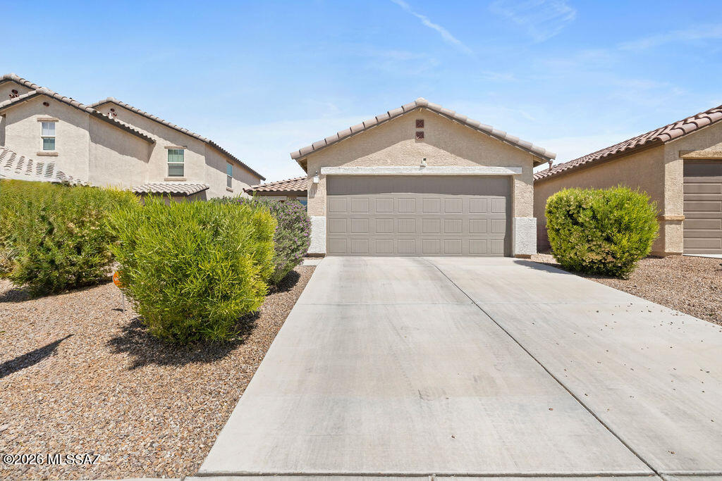 Welcome to this beautifully maintained home in the highly desirable southeast Tucson corridor! Located in the award-winning Vail School District, this property offers the perfect blend of comfort, function, and Arizona lifestyle. Step inside to an open and inviting floor plan designed for both everyday living and effortless entertaining. The spacious kitchen features ample cabinetry, generous counter space, and a seamless flow into the dining and living areas — creating the ideal hub of the home. The primary suite provides a private retreat with a well-appointed en-suite bath and walk-in closet. Additional bedrooms offer flexibility for guests, a home office, or a growing household. Out back, enjoy Arizona living at its best with a low-maintenance yard with turf, pavers and rock.