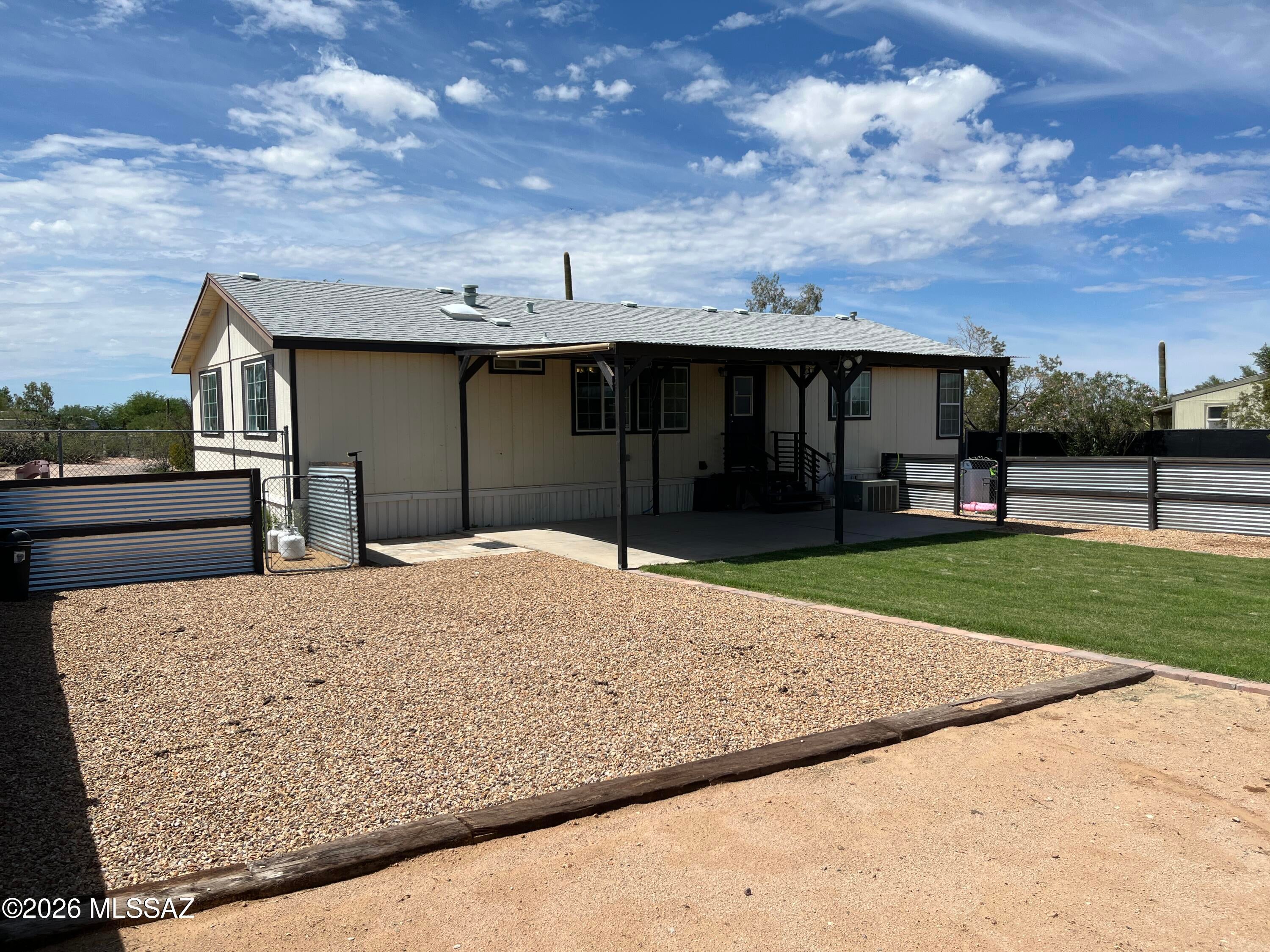 Beautiful 3-bedroom, 2-bath home on 1 acre of horse property with spectacular mountain views. Spacious open floor plan with split bedrooms, a huge kitchen with breakfast nook, garden tub, walk-in primary closet, and durable vinyl flooring throughout--no carpet! Enjoy Arizona sunsets from the covered front deck or entertain on the huge covered rear patio overlooking a private fenced yard with lush grass, irrigation, and decorative gravel. Plenty of room for horses, RVs, trailers, and outdoor toys. Enjoy the privacy and wide-open spaces of country living. Listing Agent related to Seller. Wood shed in the backyard does not convey.