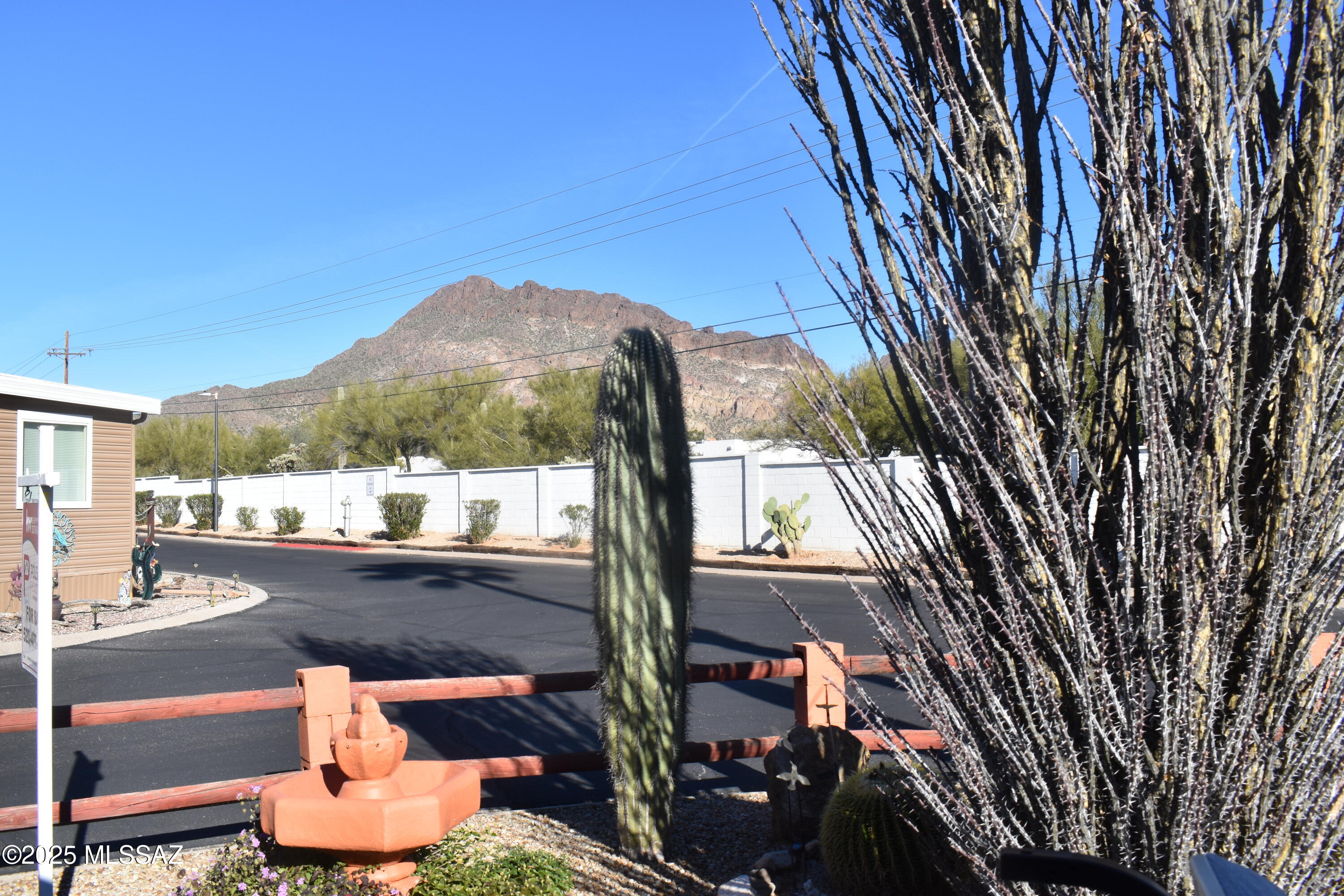 Amazing mountain views greet you from the front yard of this charming corner lot home! This quaint 1 bed / 1 bath residence offers cozy living w/ plenty of character. A welcoming family room features a window unit for extra cooling comfort, the perfect spot to greet visitors or enjoy a morning cup of coffee. The kitchen includes a gas stove & microwave for everyday convenience.

An additional entrance leads to the spacious living room, filled w/ natural light from abundant windows. Outdoors, you'll love the paver patio w/ firepit & ample wood supply, ideal for gatherings under the stars.

A storage shed has shelving, freezer, & laundry area (washer & dryer included) adds functionality.

Located in a wonderful 55+ community, amenities includes water, sewer, & garbage services.