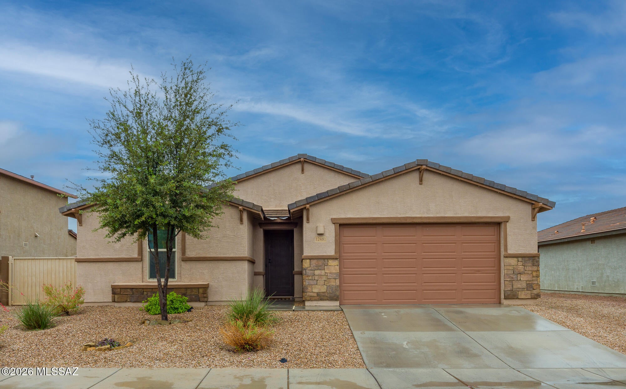 This 4-bedroom, 3-bath home sits just steps from Heritage Park in Gladden Farms, one of Marana's most sought-after communities. Plank ceramic tile flows through the main living areas, with carpet in the bedrooms for added comfort.  The chef's kitchen is made for everyday living and entertaining alike, with a large quartz island, gas cooktop, microwave, and a butler's pantry offering abundant storage. The spacious primary suite is a true retreat, featuring two walk-in closets and an en-suite bath with an impressive walk-in shower. Bedrooms 2 and 3 share a Jack-and-Jill bath, while Bedroom 4 has a bathroom right next door. The laundry room includes a washer, gas dryer, and storage, and the three-car tandem garage adds room for vehicles, gear, or a workshop.  Out back, the covered patio with a grill and seating area.