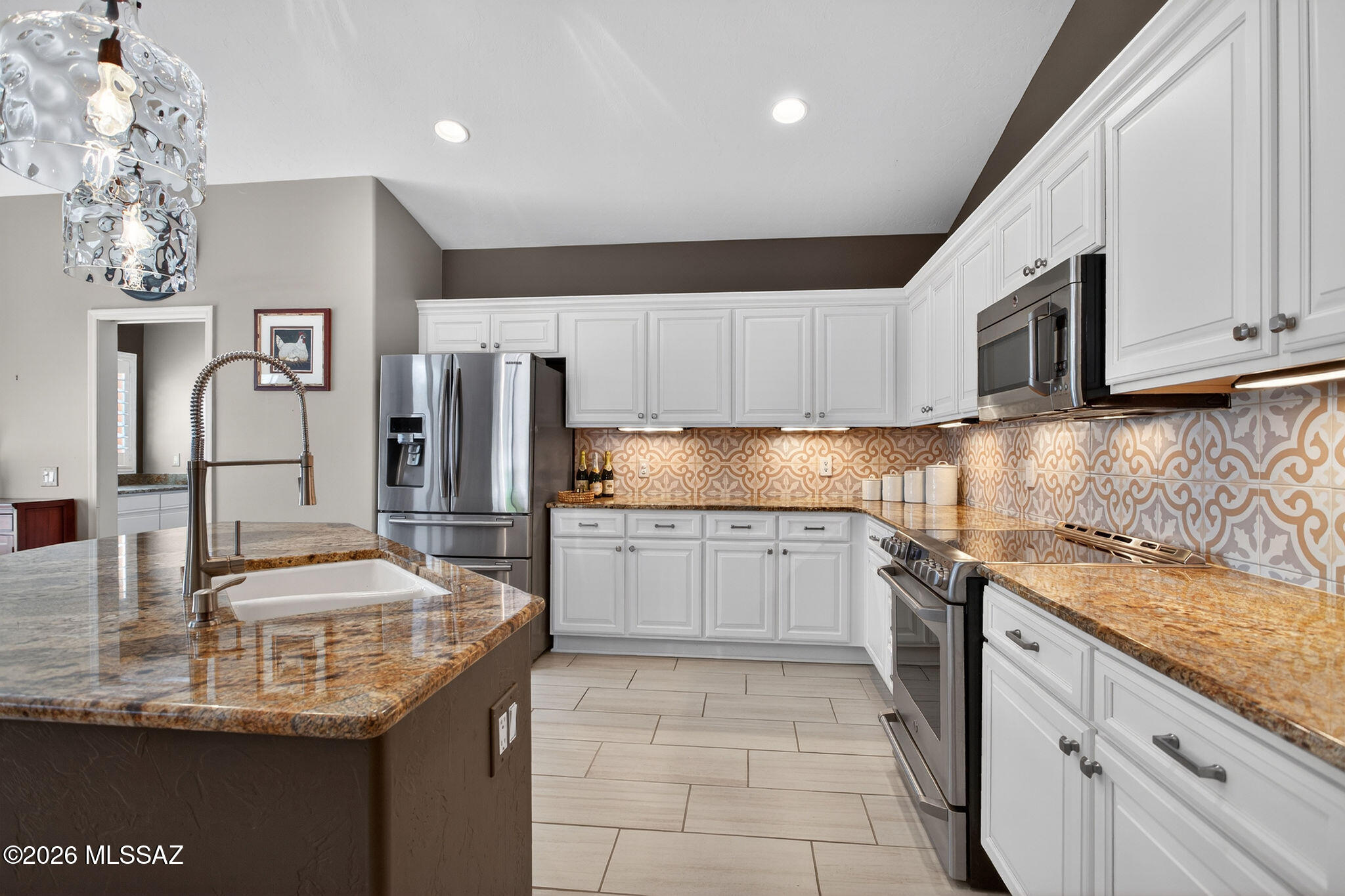 Located in the prestigious active adult community of SaddleBrooke, this expanded south-facing Montana model offers 3 bedrooms plus a den with beautifully updated finishes throughout. The remodeled kitchen features slab granite countertops, custom cabinetry, under-cabinet lighting, custom backsplash, undermount sink, and stainless steel appliances. Wood flooring flows through the living room, family room, and den, while custom plantation shutters and window treatments add warmth and elegance throughout the home. Designed for both comfort and entertaining, the home offers two spacious living areas, including a family room with built-in entertainment center and cozy gas fireplace. The upgraded bathrooms and thoughtfully remodeled interior create a move-in ready home with quality craftsmanship at every turn.

The professionally landscaped front and back yards feature a complete drip irrigation system, covered patio, extended brick paver patio, roll-down shades, and a firepit area perfect for relaxing or entertaining. Enjoy exceptional privacy in the 8-foot in-ground spa. Conveniently located near the recreation center, pickleball courts, fitness center, and dog park.

SaddleBrooke is one of Southern Arizona's premier resort-style active adult communities, located in the Catalina Foothills just north of Tucson at nearly 3,500 feet elevation, offering cooler temperatures and year-round outdoor living. Residents enjoy multiple golf courses, fitness centers, swimming pools, tennis and pickleball courts, clubhouses, restaurants, social clubs, and endless community activities.
