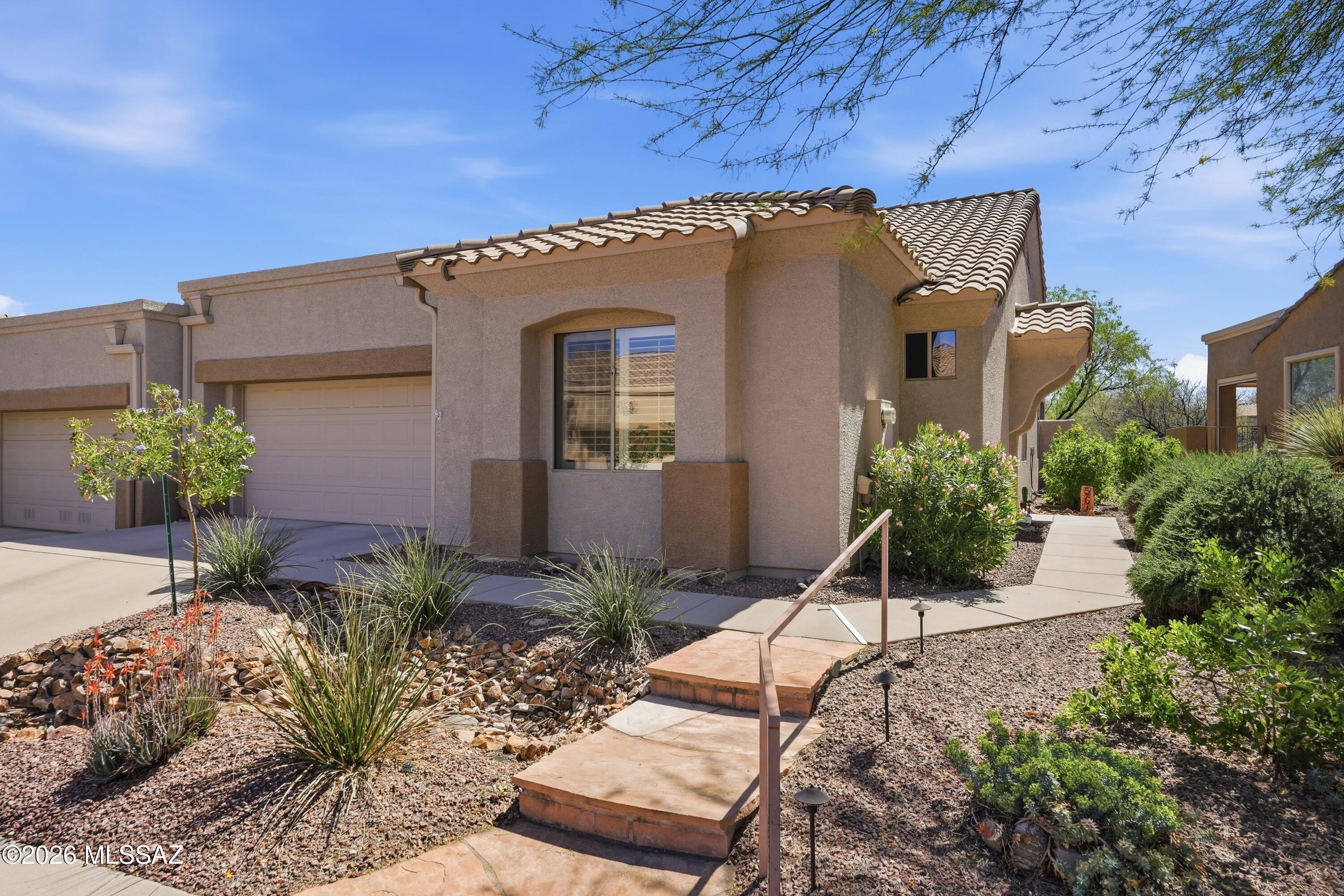 This two-bedroom, two-bathroom home offers approximately 1,516 square feet of living space within a gated community. Featuring all-tile floors, granite countertops and stainless steel appliances in the kitchen, and a laundry area with additional storage conveniently situated between the kitchen and garage. You can be in the kitchen and still be visiting with your guests sitting at the granite breakfast bar. The living area is an enjoyable space to watch your favorites on TV or sit and visit with family and friends. The primary bedroom includes a bay window for additional floor space and natural light. The primary bathroom offers a  double vanity and walk-in closet, while the guest bedroom is equipped with a murphy bed and walk-in closet. MORE... The dining area located within the great room also has a bay window for more space. The covered back patio with a ceiling fan and roll-down sunshade is fenced and gated with access to the community park. The back patio offers two separate areas, one covered for sun free enjoyment, while the other is uncovered for a sport in the sun.