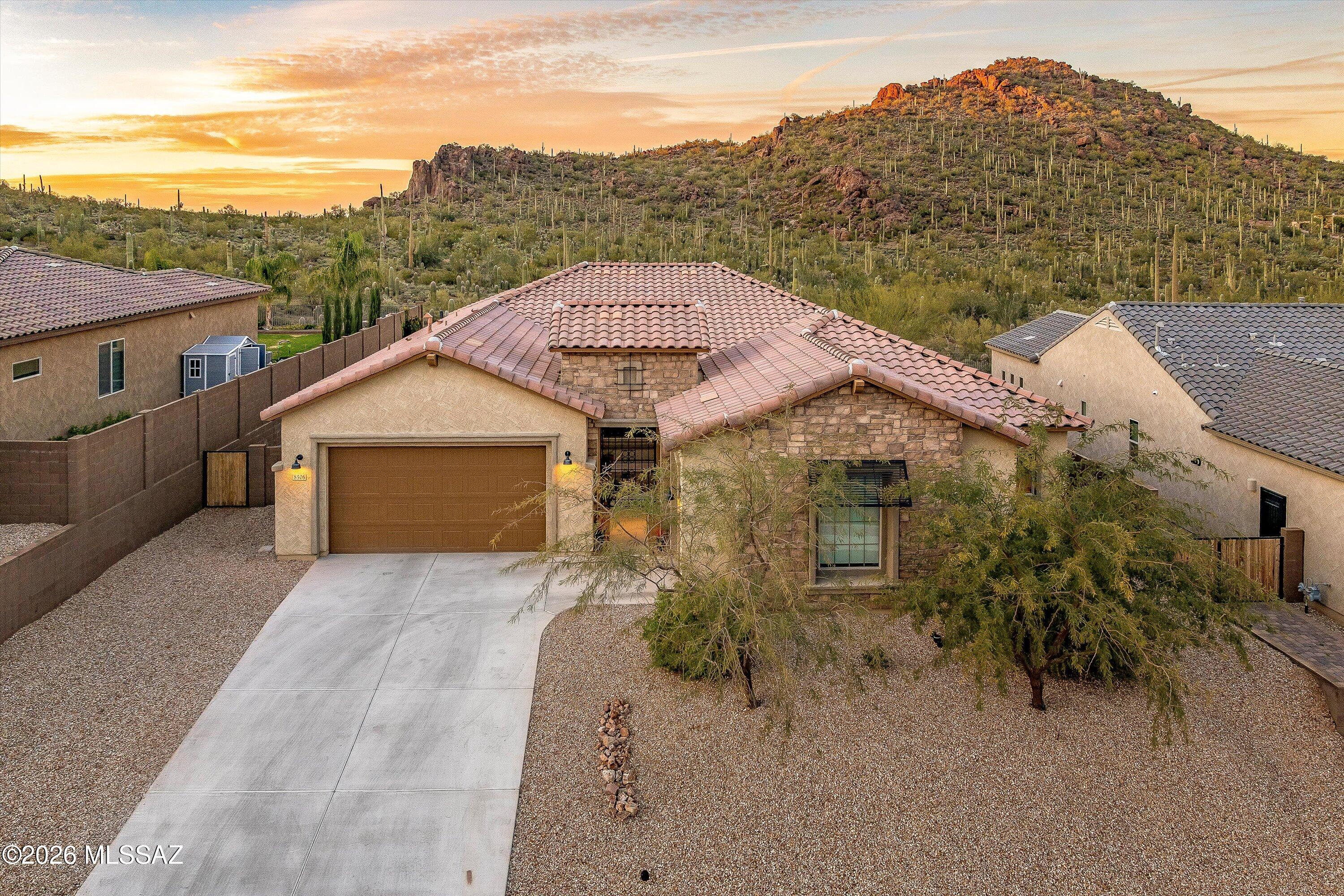 Perfectly positioned on a premium cul-de-sac lot with no rear neighbors and unobstructed mountain views, this extensively upgraded and meticulously maintained home offers exceptional privacy and tranquility without sacrificing convenience. Ideally located near shopping, dining, schools, and I-10, the gated enclave of Lazy K Bar Ranch is nestled along the Tucson Mountains, bordering Saguaro National Park West. This residence is truly a standout within the community. 

In addition to four spacious bedrooms and three-and-a-half baths, the thoughtfully designed layout includes a private den/office, a flex room ideal for media space, and a third garage bay for additional storage. A secondary bedroom with an en-suite bath offers exceptional comfort for guests. At the heart of the home, the entertainer's kitchen impresses with extended cabinetry, an oversized island, Café double electric convection ovens with French doors, a wine chiller, and a dedicated beverage refrigerator perfect for hosting in style. Seamlessly extending the living experience outdoors, the covered patio is enhanced with wireless speakers, inviting you to relax and entertain while taking in the dramatic desert sunsets. Every detail has been curated for elevated living, including custom shelving in the pantry and closets for impeccable organization. Offering unparalleled views, refined finishes, and flexible living spaces, this exceptional home embodies the luxury desert lifestyle - where beauty, comfort, and convenience converge.