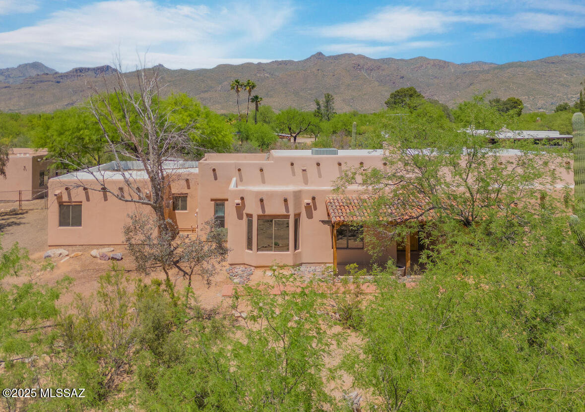 Nestled on a full acre in the desirable Bel Air Ranch community, this exceptional property offers space, flexibility, and value rarely found at this price point. This is horse property and no HOA makes this true Arizona living with room to grow. The main residence spans over 3.600 square feet and features 4 bedrooms, 2.5 bathrooms, a 2-car garage, and a warm, inviting wood-burning fireplace--perfect for cozy evenings. Recent updates include a newer roof and fresh interior paint, making the home move-in ready for its next owner. Step outside to enjoy a covered rear patio overlooking a private pool--ideal for entertaining or relaxing while taking in the expansive surroundings. What truly sets this property apart is the detached guest house, offering over 1,100 square feet with 2 bedrooms 1 1 bathroom. Whether used for multigenerational living, rental income, or private guest accommodations, this additional space provides unmatched versatility. Located within the highly regarded Tanque Verde School District, this property combines rural freedom with access to top-tier education. Recently reduced to $815,000, this home presents a compelling opportunity, with comparable properties supporting values near $900,000. A rare combination of land, livable space, and long-term potential--this is one you don't want to miss.