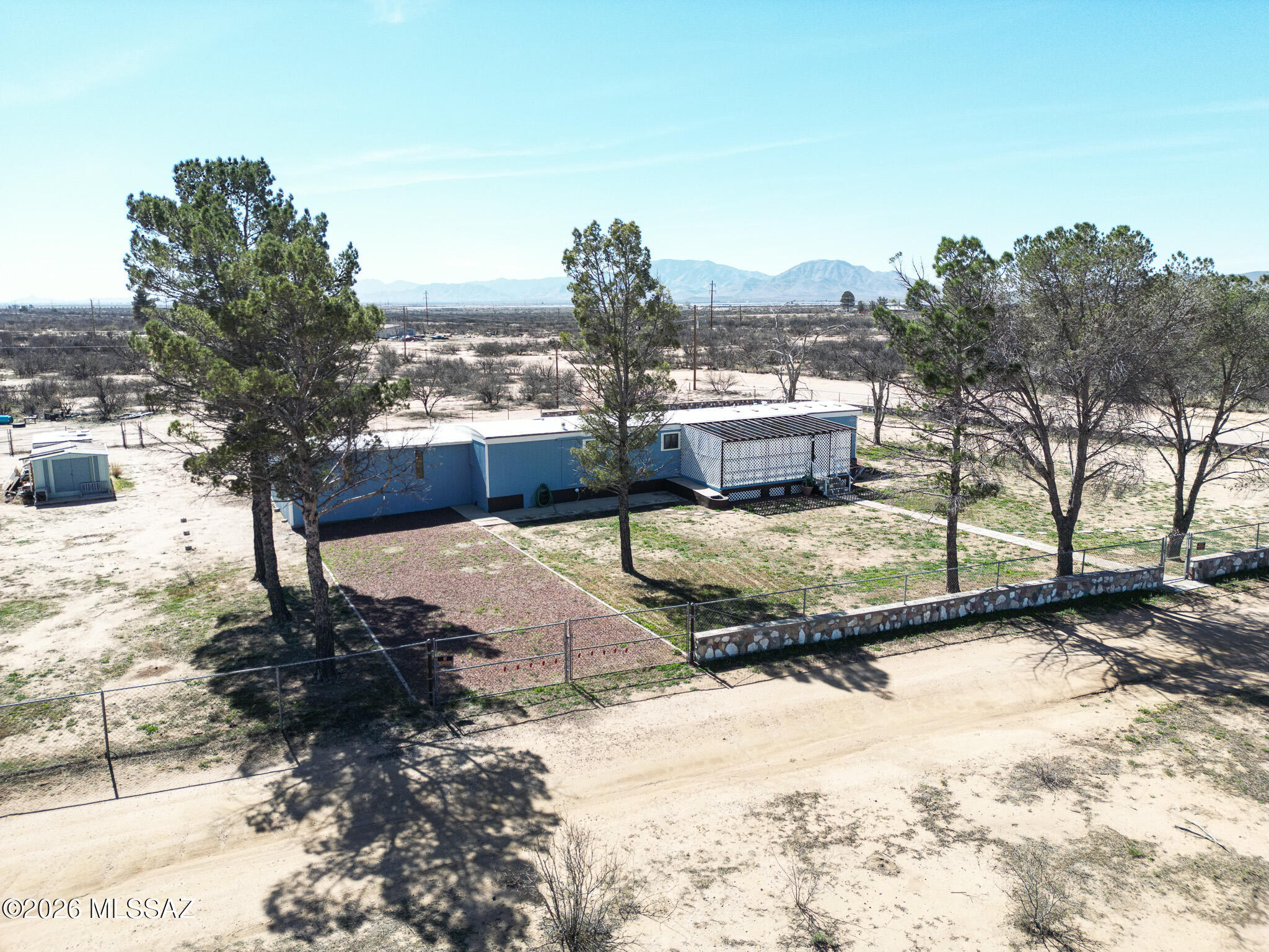 This charming property offers the perfect blend of privacy and beauty.. The home sits on .70 acres that are fully fenced and gated,, highlighted by a concrete wall with vibrant colored stones sourced from a local mine. This 980 sq ft home features 2 bedroom and bathrooms, an attached shop (338 sq ft) and two storage sheds. Enjoy the front and back porches, ideal for morning coffee and evening sunsets. Every aspect of this home has been thoughtfully maintained and improved, allowing for the next owner to move in with confidence. Three additional lots, equaling 1.41 acres, are included to the South of the home. All furniture and contents are included!!!  If you're looking for quiet country living with character, craftsmanship and panoramic views, this property is ready to welcome you.