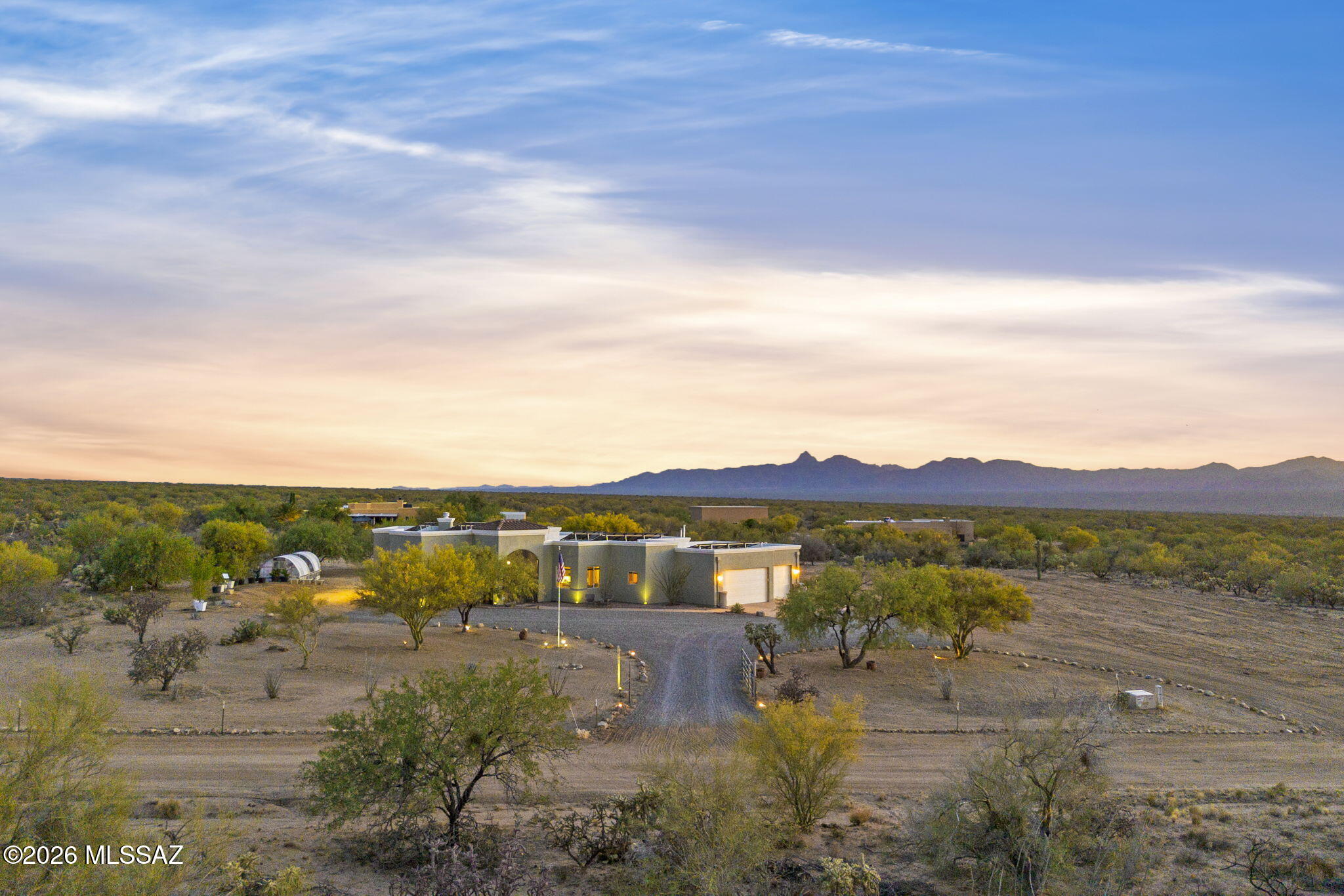 Welcome to your desert retreat in the desirable Diamond Bell Ranch Community! This contemporary 3-bedroom, 2.5-bath home is perfectly situated on 3.64 acres of an open desert setting with breathtaking panoramic mountain views. Enjoy stunning sunrises from the Arizona room and unforgettable sunsets right from your own backyard patio. This home offers the perfect balance of peaceful privacy and city convenience. Inside, the spacious kitchen features granite countertops, updated smart appliances, a commercial gas oven/cooktop, a breakfast bar, breakfast nook, and beautiful custom Alderwood cabinetry. The split-bedroom floor plan provides added privacy, while the private primary suite offers a walk-in closet, separate jetted tub, walk-in dual head shower, and dual his-and-her vanities. A charming wood burning fireplace creates warmth and character, opening to the great room for cozy enjoyment.

Additional highlights include a separate laundry room with updated washer and dryer, sink, generous counter space, and abundant storage, a large 3-car garage, screened-in patios, a 20' above-ground swimming pool, and a dual temperature swim spa/hot tub combo--perfect for relaxing and entertaining year-round.  Solar is included. 
Experience the beauty of Arizona living in this one-of-a-kind gem in the desert!
