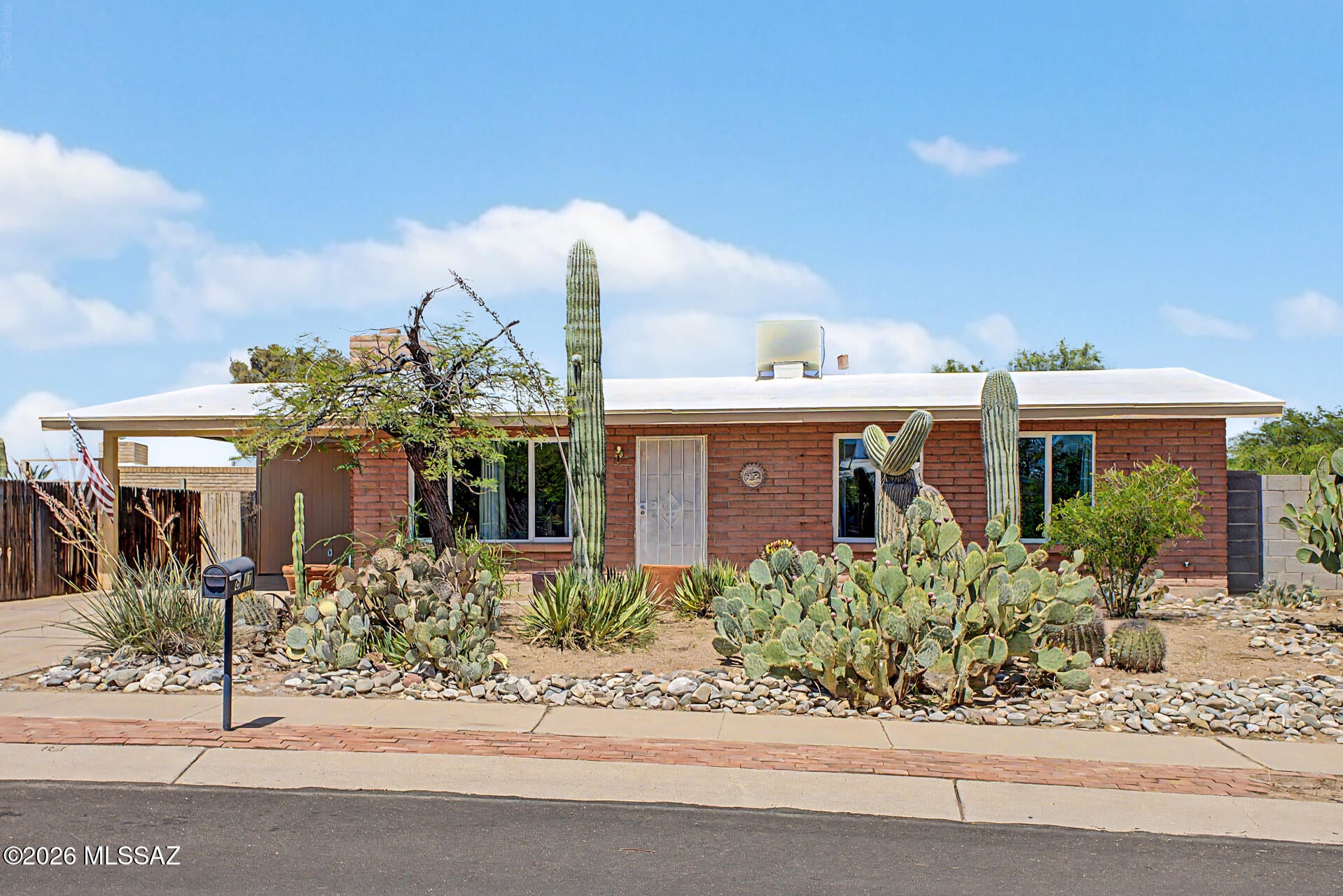 Experience move-in ready comfort in this well-maintained, 1,037 sq.ft. slump block home featuring 3 bedrooms and 2 full bathrooms. This gem boasts stunning panoramic views, with the Rincon Mountains visible from the front and the Catalina Mountains from the back. Situated on an oversized, north/south-facing corner lot with no HOA, this property offers incredible versatility with a double RV-size gate, professional landscaping, an open backyard, a storage shed, fire pit, and mature trees--perfect for hobbies or recreation. Energy efficiency is a priority, highlighted by double-pane Argon gas windows, insulated interior block walls, and an HVAC system with an optional swamp cooler. The interior has been freshly painted throughout and features durable ceramic tile (no carpet), a cozy wood-burning fireplace with a custom mantle and red brick hearth, and updated conveniences including new sunshade curtains and easy-open blinds. Enjoy new exterior paint for peace of mind.  Located in a prime eastside neighborhood, you will enjoy close proximity to schools, parks, shopping, dining, and outdoor recreation.