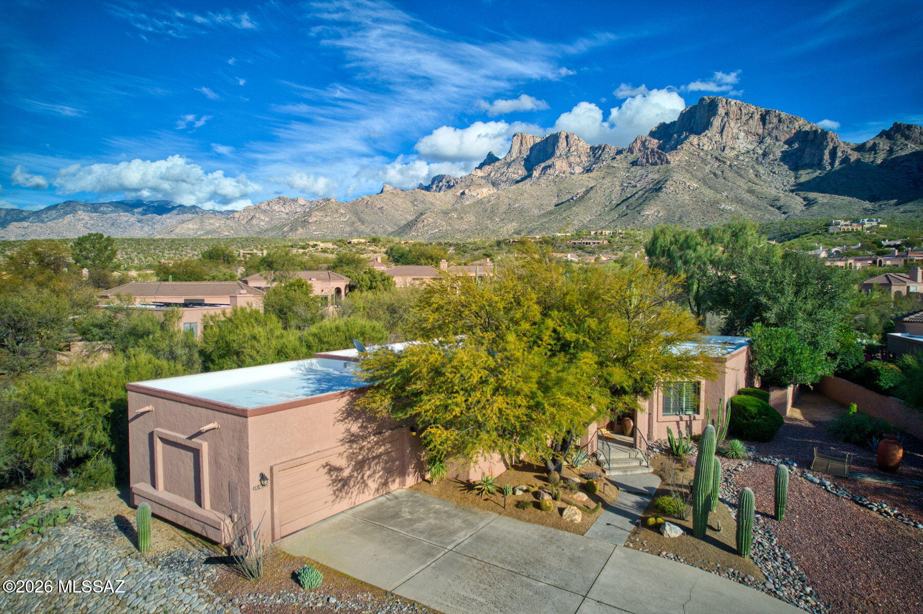 Set behind the gates of the coveted La Reserve community, this distinctive 3BR/2.5BA home blends timeless style & everyday comfort, framed by incredible Catalina Mountain views from the private backyard retreat. The hillside lot backs to HOA-owned open space, offering rare privacy. Inside, enjoy an open layout with over 2,300 sq ft & soaring ceilings. Notable improvements include custom Alder cabinetry, granite countertops, SS appliances, a newer built-in refrigerator & a brick accent wall over the fireplace. The owner's suite features more mountain views, a jetted tub, travertine tile & a steam shower. Expansive windows capture Catalina Mountain views from multiple vantage points throughout the home!