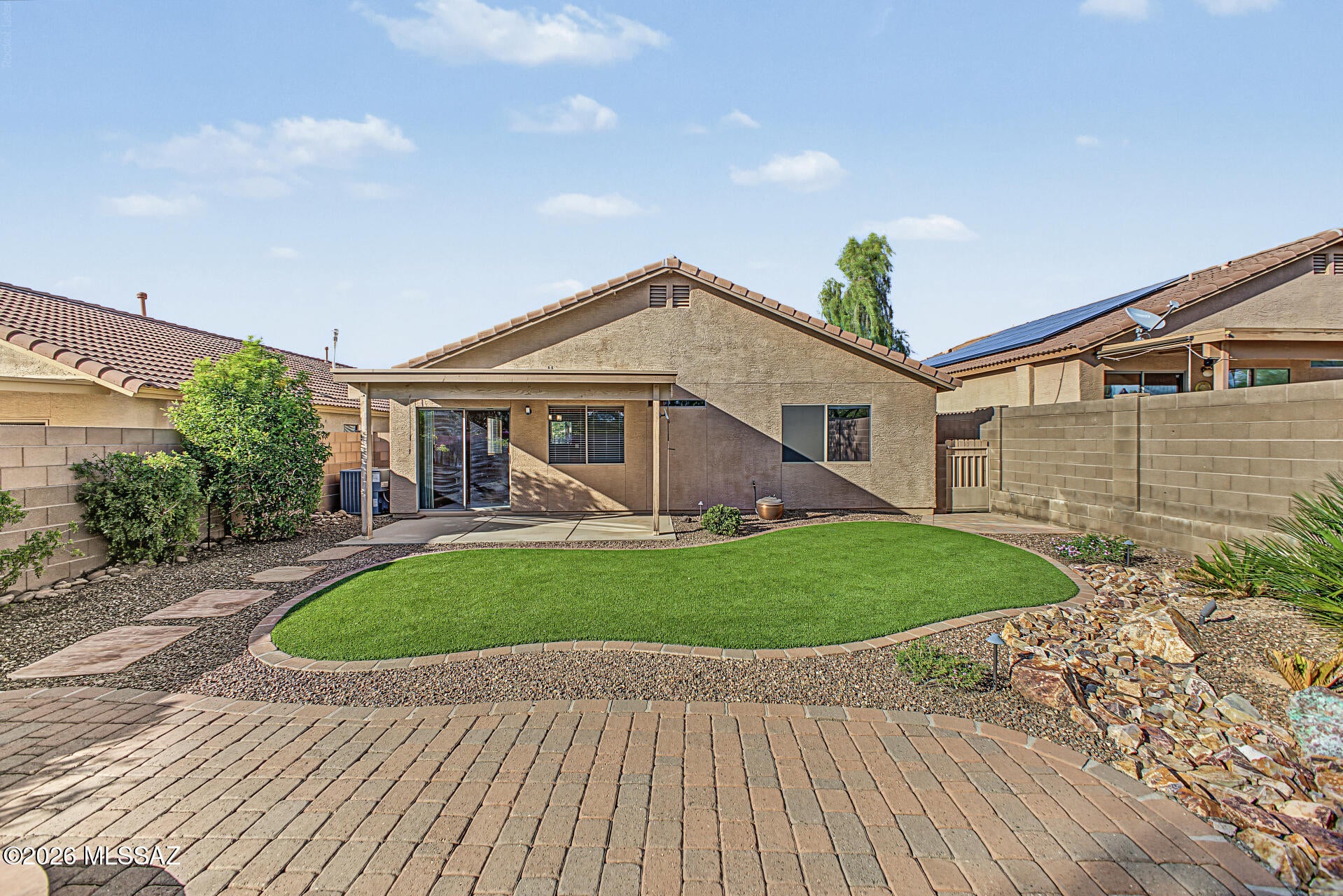 Located in desirable Northwest Tucson, just minutes from Oro Valley, AZ! This charming 3-bedroom, 2-bath home offers 1,308 square feet of thoughtfully designed living space with an inviting living roomand a kitchen featuring granite countertops, stainless steel appliances, and a farmhouse sink. Both bathrooms have been remodeled, adding to the home's appeal. Step outside to a backyard designed for relaxation and entertaining, complete with an extended paver patio, artificial turf, and a cozy fire pit--perfect for enjoying Tucson's beautiful evenings and breathtaking sunsets. Paved area with electric wiring for you to add a spa. Low-maintenance landscaping makes outdoor living effortless, while the two-car garage provides additional convenience. Ideally situated near shopping, dining, parks, and everyday amenities, this home offers a wonderful combination of comfort, convenience, and Arizona charm. Come see what makes this home special!