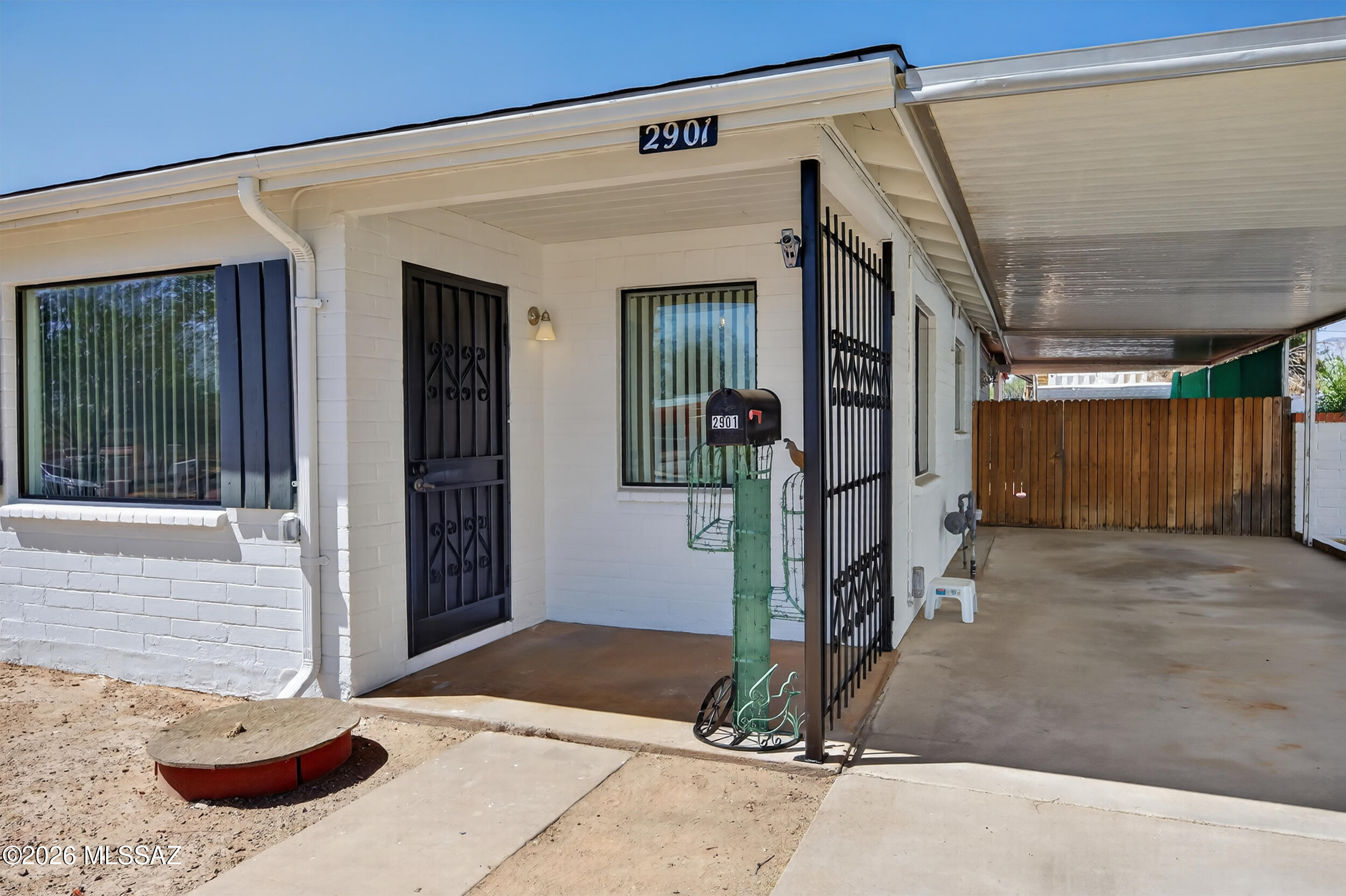 Charming One-Owner Home Near Reid Park.  No HOA! This well-maintained property offers comfort and flexibility, featuring a new roof, fresh interior and exterior paint, new bedroom carpets, and a new dishwasher.  In addition to a spacious family room with a cozy wood-burning stove, the home includes a formal living room and dining area, perfect for entertaining.  The bonus room offers versatility as a third bedroom or office. Step outside to enjoy a backyard with a covered patio, ideal for relaxing or gatherings.  Double and rolling gates provide easy access for ample parking under a large awning. A detached 170 sq/ft workshop with electricity and a new roof, plus a generous covered workspace. Three storage units with built-in shelving add abundant storage.