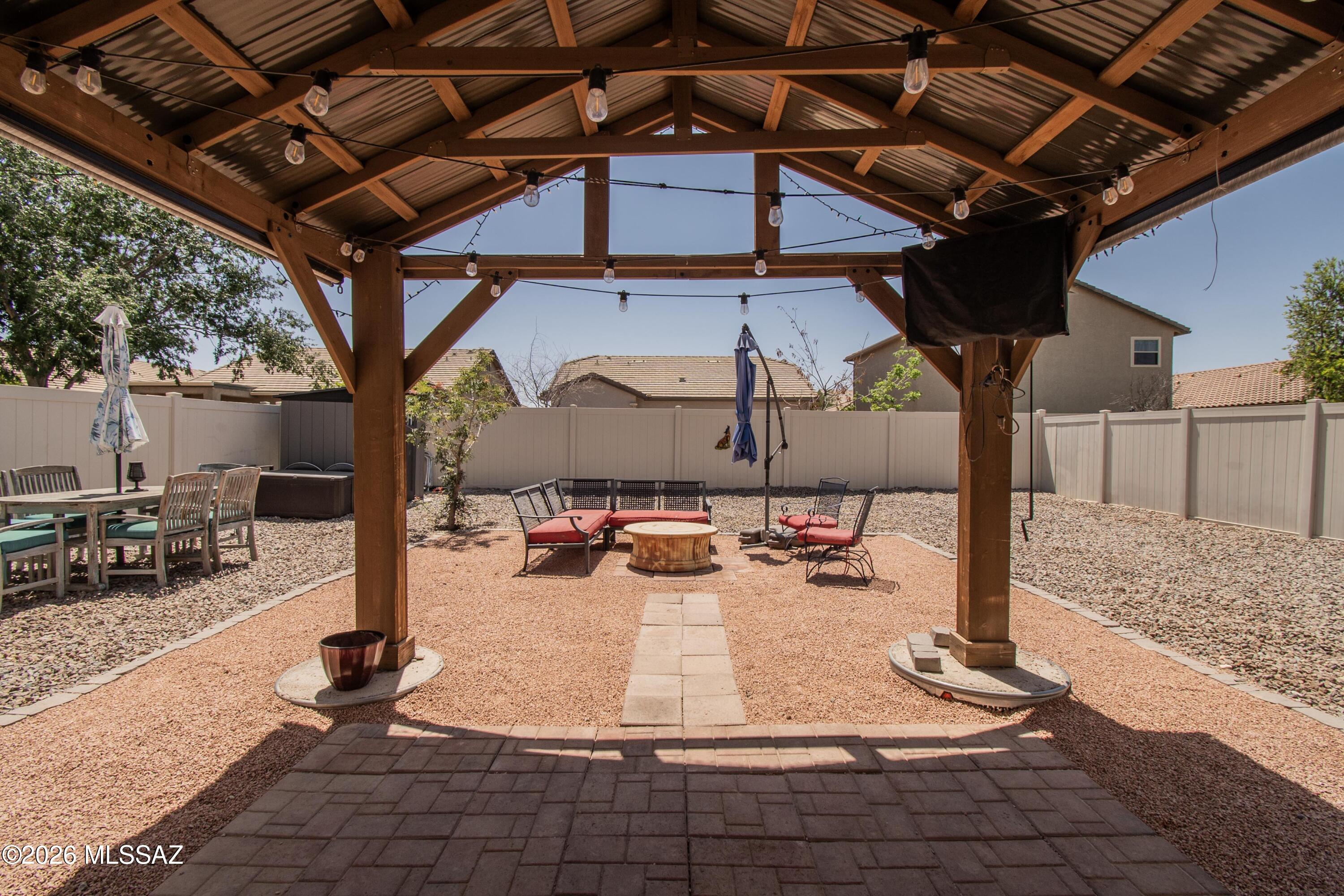 Beautiful, energy-efficient home in the desirable Red Rock Village community! This spacious 3 bed, 3 bath home offers great features throughout, including free-and-clear solar, an EV garage charging station, dual-pane windows, water heater & A/C unit less than 5 years old. The kitchen is equipped with stainless steel appliances, including a 4-door refrigerator that conveys. Upstairs offers a versatile loft perfect for additional living space, a home office, or flex area. French doors lead to a landscaped backyard featuring a new covered patio with shade screens, pavers, and a seating area with a fire pit ideal for relaxing Arizona evenings and entertaining. Many furniture items throughout the home and backyard, including a new Samsung washer and dryer set, are available with an acceptable offer or on a separate bill of sale. Don't miss all the community amenities, including a swimming pool, skate park, basketball courts, baseball fields, volleyball courts, and more.