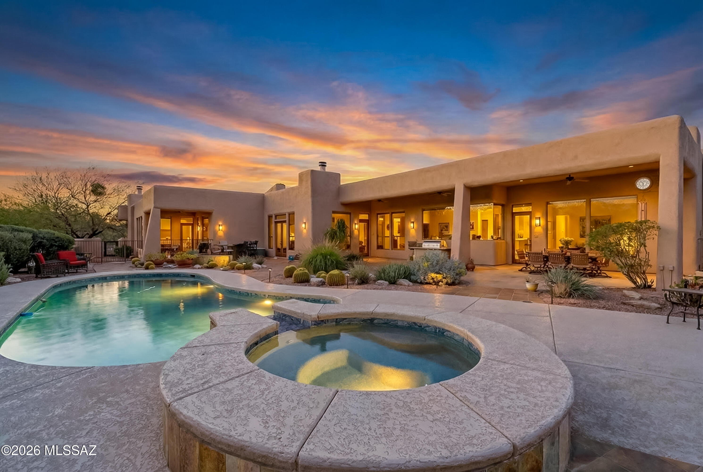 Positioned to capture stunning Catalina Mountain views, this thoughtfully updated residence blends generous scale with refined finishes and seamless indoor-outdoor living. High ceilings and expansive windows fill the home with natural light, while the no interior steps layout offers comfortable, accessible single-level living.
The well-designed floor plan features five bedrooms and four bathrooms, providing exceptional flexibility for guests, work-from-home needs, or multigenerational living. At the heart of the home, the kitchen showcases custom cabinetry, quality finishes, and ample workspace, opening naturally to the main living areas for easy everyday living and entertaining.
Throughout the home, 8-foot alder interior doors and tile flooring create a cohesive, upscale feel, while three fireplaces add warmth and architectural presence across multiple living spaces. The spacious three-car garage provides abundant storage and functionality.
Outdoor living is equally compelling. The backyard is oriented to maximize the mountain backdrop, with a pool and spa creating a true resort-style setting for relaxing or entertaining under the Tucson sky.
Recent mechanical improvements--including dual new HVAC systems (2025), a new tankless water heater (2026), and a roof recoated in 2025--offer meaningful peace of mind and long-term value.
With its combination of views, thoughtful updates, and flexible living spaces, this home presents a rare opportunity to enjoy elevated desert living in a highly desirable setting.