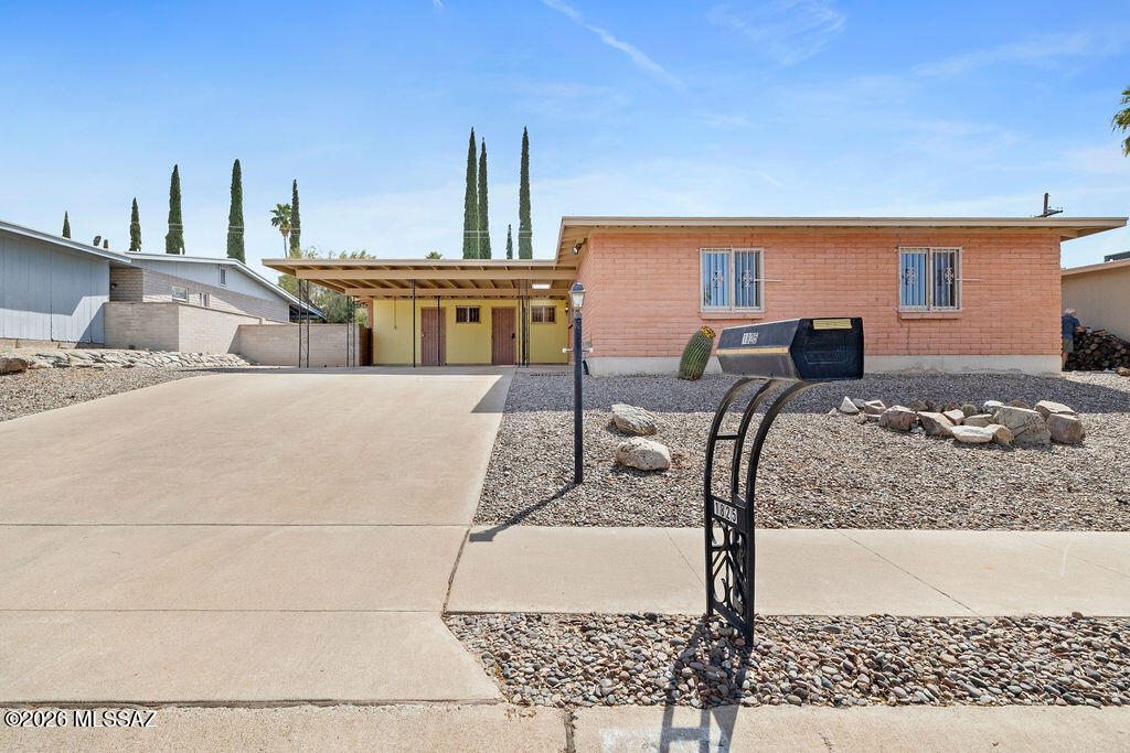 This home has been recently renovated, while still maintaining its classic Tucson feel. Upon entering, you are greeted with all new LVP flooring, which runs throughout the entire house. There are two living spaces, a dining area, and large kitchen, perfect for entertaining. Updates include a newer HVAC, newer paint, and remodeled bathrooms. The bedrooms are spacious and have new dual pane windows. The backyard has a sprawling patio and mature trees providing plenty of shade and fruit. All appliances are included making this home truly move-in ready! Situated in the Rolling Hills neighborhood on Tucson's east side, this quiet community features a semi-private golf course, allowing you to hone in on your skills and giving you the perfect place to take advantage of the Arizona sun year-round!