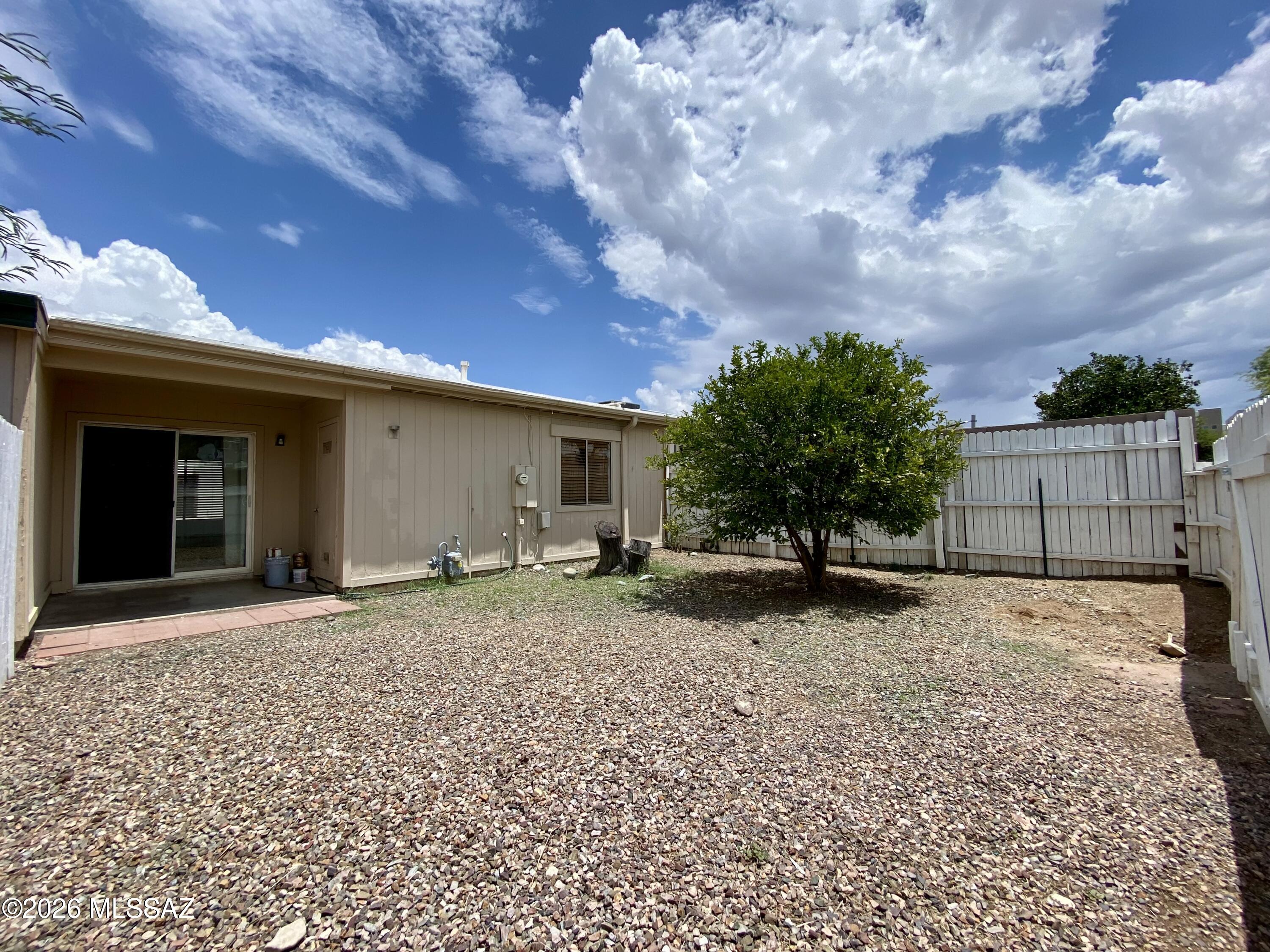 Affordable Tucson living with a private backyard! This 2-bedroom, 1-bath east-side townhouse is clean, move-in ready, and offers an inviting alternative to renting. Natural light from skylights brightens the kitchen and bathroom, while a separate exterior laundry room adds practical convenience. Step outside to a spacious private backyard with room for outdoor dining, gardening, pets, or simply relaxing under the Tucson sky. Two designated parking spaces are located directly in front of the home. If you've been looking for an affordable place to call your own, this one is worth seeing.