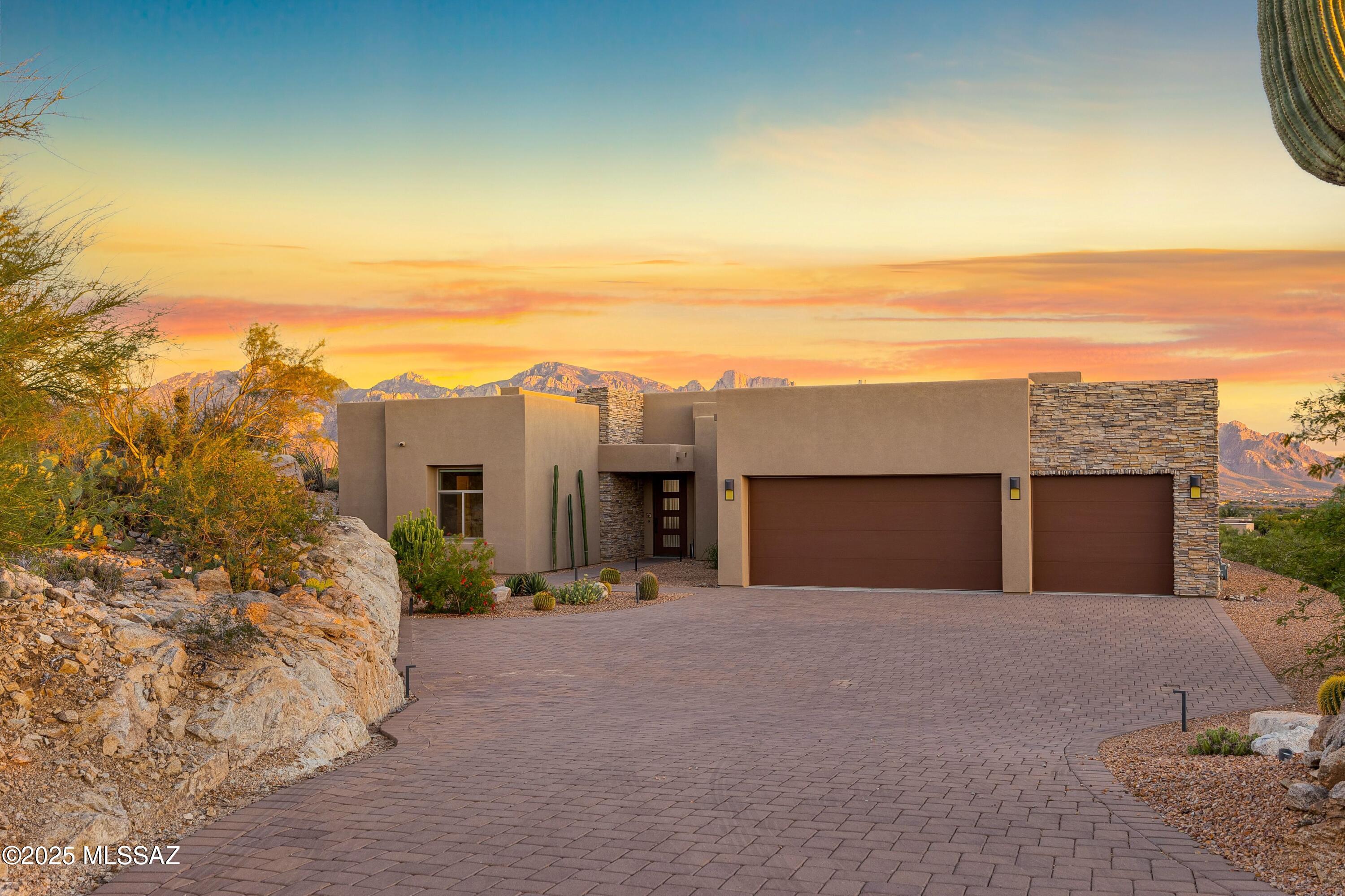VIEWS! Set to embrace sweeping views of the Catalina Mountains and glittering city lights, this exceptional homesite offers a rare dual panorama-sunlit desert vistas by day and a luminous skyline by night. Thoughtfully designed with simplicity and intent, the 2,794 sq. ft. residence features three bedrooms, a dedicated office, and a generous three-car garage. Every detail reflects a commitment to quiet luxury and seamless connection to the land.
Set within the gates of Stone Canyon, this residence offers more than just a view. Homeowners enjoy access to one of Arizona's most prestigious golf courses, a private restaurant reserved exclusively for residents, and a state-of-the-art health & fitness center. It's a lifestyle of serenity. 
Call today for a private tour! Set within the gates of Stone Canyon, this residence offers more than just architectural grace. Homeowners enjoy access to one of Arizona's most prestigious golf courses, a private restaurant reserved exclusively for residents, and a state-of-the-art health and fitness center. It's a lifestyle of serenity, sophistication, and community. This is not just a home, it's a story of foresight, design, and timeless desert beauty. 
Call today for a private tour!