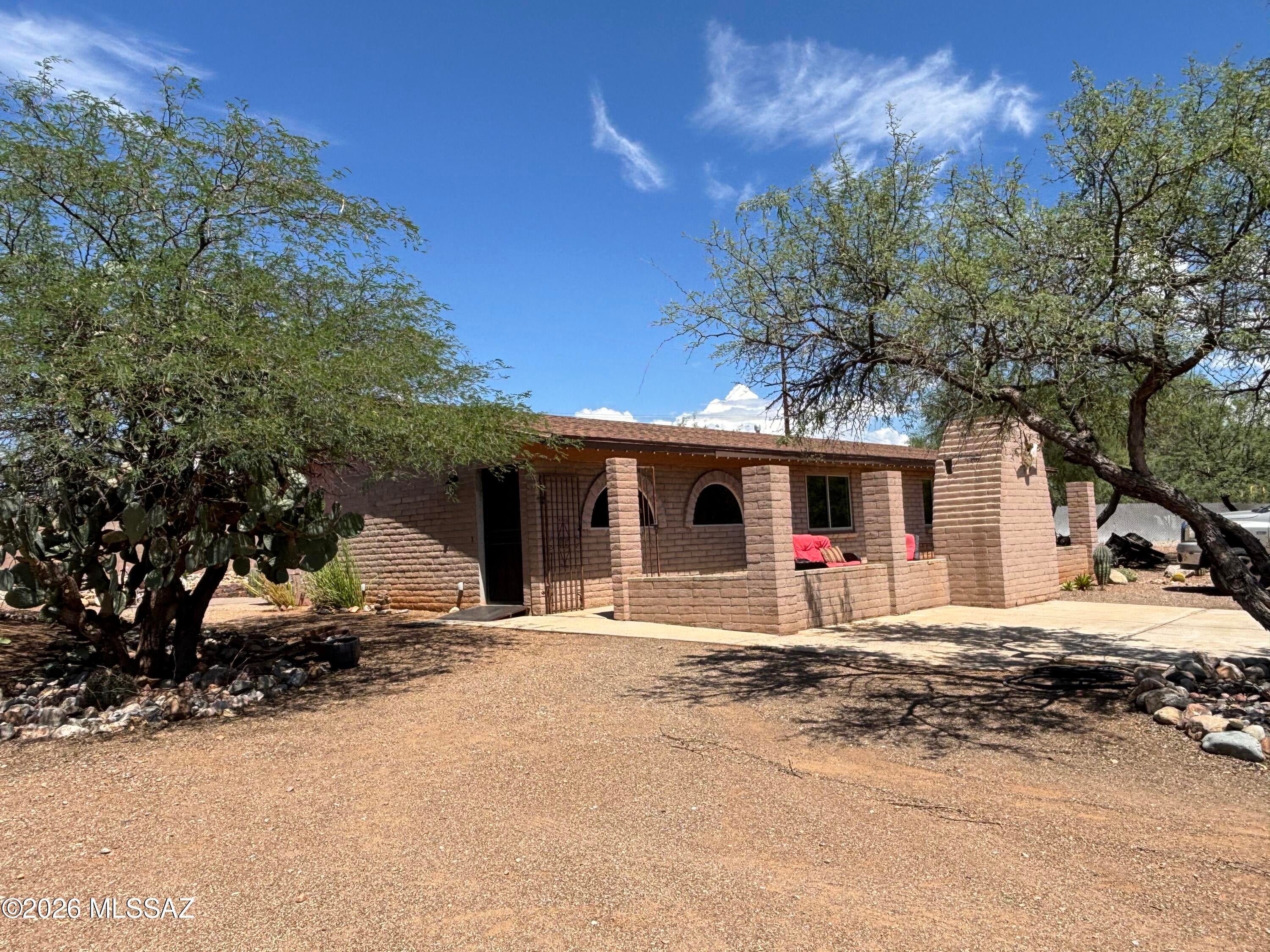 Enjoy breathtaking Catalina Mountain views from this beautiful and spacious home, ideally situated on a generous 1-acre corner lot. Designed for comfortable living and effortless entertaining, this property features an open great-room floor plan with decorative concrete flooring throughout, creating a warm and inviting atmosphere.

The well-appointed kitchen is the heart of the home, featuring a gas range, stainless steel appliances, a deep kitchen sink, abundant counter space, and an oversized counter, breakfast bar. The open layout seamlessly connects the kitchen and living areas, making it perfect for hosting family and friends.

The spacious primary suite offers beautiful mountain views and a large walk-in closet complete with a built-in safe. The primary bathroom features a walk walk-in shower with a stylish Pebble floor, creating a relaxing retreat.

A true standout feature of this property is the oversized detached garage, offering exceptional versatility with room for large vehicles, a workshop, hobbies, and abundant storage. The garage is also equipped with evaporative cooling for added comfort.

Set against the stunning backdrop of the Catalina Mountains, this unique property offers space, privacy, functionality, and incredible desert charm. A rare opportunity and true jewel in the desert--this home is a must-see!