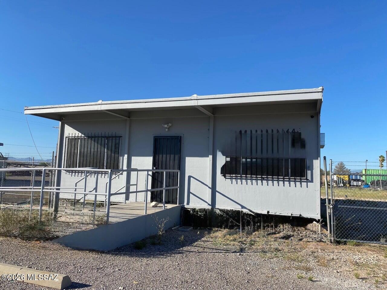 Modular building with large fenced 1/4 acre yard located along Benson Highway with I-10 access in proximity. Air conditioned, restroom with shower. Lots of possibilites for this space! Modified lease. Tenant is billed for electric use and partial water cost. Alarm service available at additional cost.