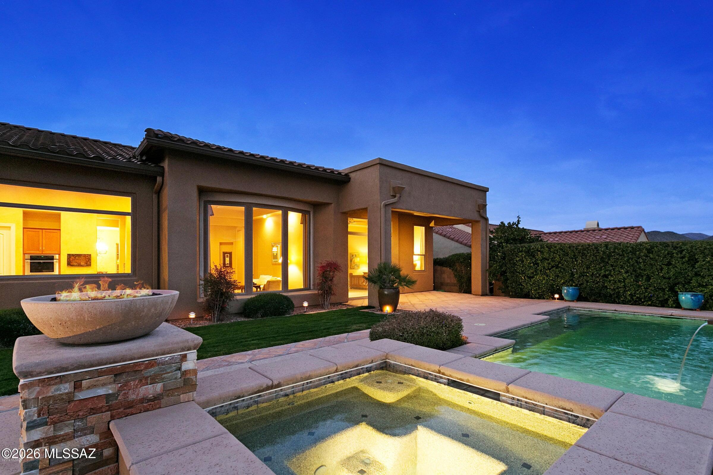 Panoramic mountain and city-light views take center stage in this rarely available Catalina model in The Preserve at SaddleBrooke! Enjoy resort-style outdoor living with a heated pool and spa, water feature, and built-in BBQ/bar. Inside, picture windows showcase the spectacular views, while the family room features a limestone-tile gas fireplace with stacked-stone accent wall. The chef's kitchen offers Stonite countertops, professional-grade stainless appliances, double convection ovens, gas cooktop, built-in refrigerator, 42-inch cabinetry, walk-in pantry and butler's pantry. New bedroom carpet, en-suite guest bedroom, laundry sink and separate guest quarters with full bath and beverage refrigerator complete this exceptional home. Fountain conveys as is.
