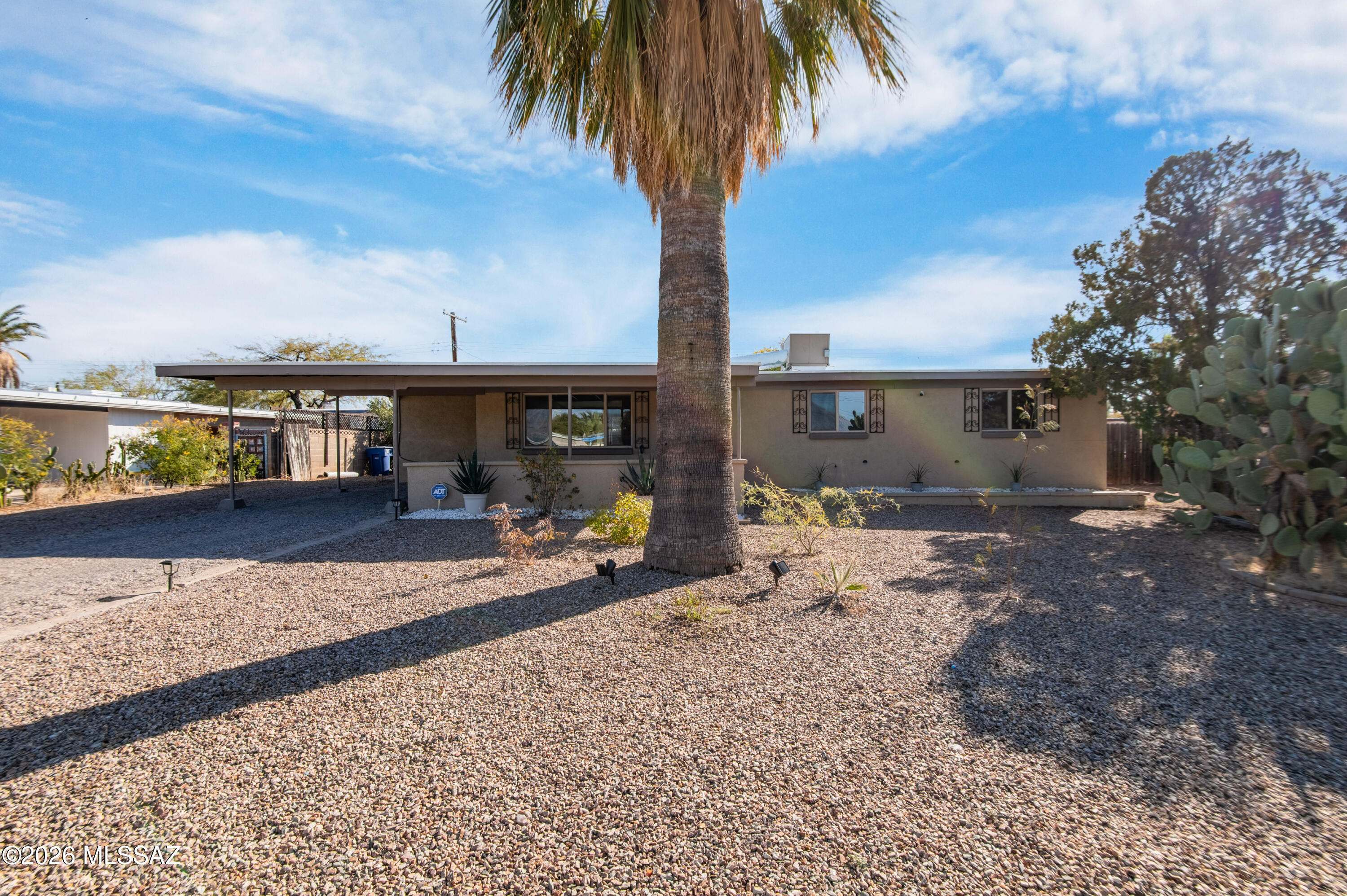 Move-in ready 4-bed, 2-bath home with a spacious layout! Enjoy tile flooring throughout, cozy carpeted bedrooms, and newer cabinets with sleek granite countertops. Relax on the covered patios in the front and back, perfect for outdoor living. The large yard offers endless possibilities. Conveniently located near Davis-Monthan AFB, shopping, restaurants, parks, and more. A fantastic home in a prime location, don't miss out!