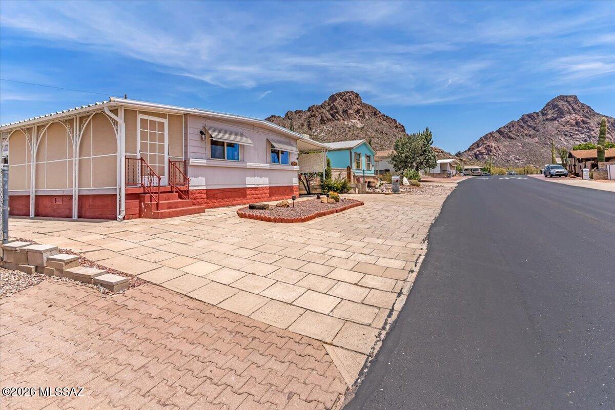Brand New Roof 2026. Resort style living at an affordable price in this 55+ community. Kitchen is updated with a new gas stove and Modern cupboards. Updated bathrooms feature walk-in showers, modern vanities, and toilets. Step outside the primary bedroom to a deck, perfect for enjoying a quiet morning coffee. Large screen AZ room. Blocked wall Golf Cart garage and an additional shed with laundry hookups. HOA includes unlimited golf, two sparkling pools, pickleball, spa, Community Center, hiking trails and YOU OWN the LAND.
