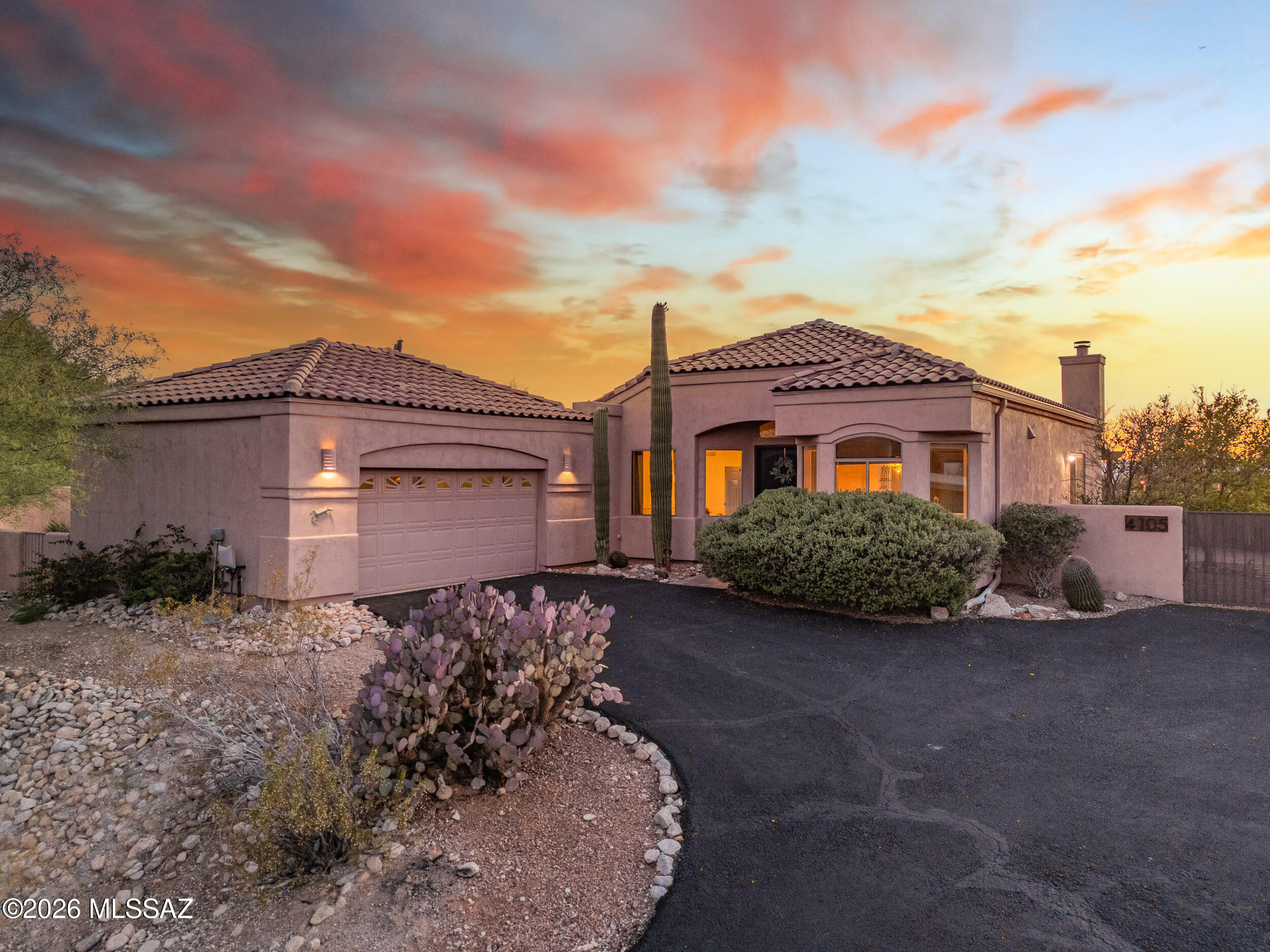 Perched atop a stunning 1.22-acre Catalina Foothills lot, this single-story 3-bedroom, 2-bath + den retreat delivers sweeping mountain, sunset, and city views that take your breath away. The open great room flows effortlessly outdoors through two sets of doors - one to the extended  paver patio, the other to a private back balcony, perfectly framing Arizona's iconic desert at every turn. Unwind in the bubbling hot tub as the sky glows at golden hour, or retreat to the spacious primary suite complete with soaking tub and walk-in closet. Mature citrus trees and native desert vegetation add charm and privacy to the low-maintenance yard. A 2-car garage completes this move-in ready hilltop sanctuary where privacy, views, and luxury converge in one exceptional home.