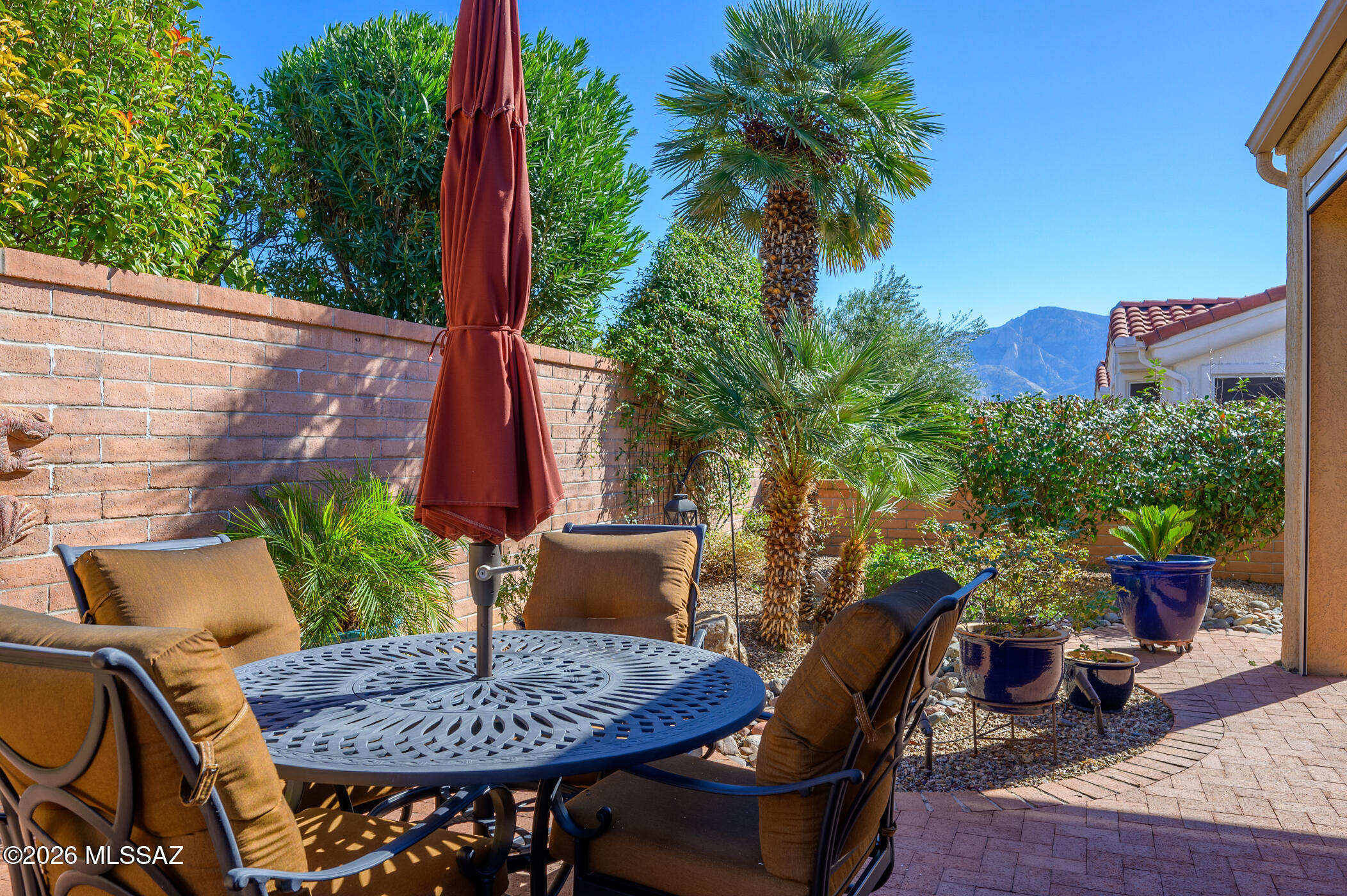 This charming, Sun City Essex model home, features 2 Beds, 2 Baths, a separate office/den & a flex room. You'll enjoy Catalina Mountain views from the welcoming front courtyard. Upon entering, you'll be greeted by the spacious living & formal dining room - both with easy access to the kitchen & family room. Showcasing plenty of cabinet space, the bright Chef's kitchen has updated countertops & tile backsplash, a center island with breakfast bar plus sleek black appliances. The spacious owner's suite is a welcoming retreat off a separate hallway & invites you in with its soft colors & pretty backyard views. The en-suite bath has a large walk-in closet, soaking tub, a separate shower & dual vanity. The guest bedroom features a large, triple-doored closet plus easy access to the guest bath. You'll enjoy the den/office, which is located just off the foyer, plus another flexible workspace/bonus room which could be great for hobbies, crafts or extra storage. The inviting, fully fenced & walled backyard has a covered and extended brick patio, electric sunshades and some Catalina Mountain views. This well-kept and inviting home is a must-see! Begin your active adult lifestyle today!