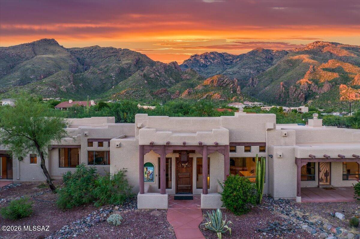Luxury, Light & Unforgettable Views in Alta Vista. Set in the prestigious Catalina Foothills, this exceptional Santa Fe-inspired residence captures dramatic Catalina Mountain views by day, glowing sunsets in the evening, and sparkling Tucson city lights after dark.
Rich architectural details give this home a character all its own. Soaring cedar ceilings, exposed viga beams, and Mexican Borgata brick floors bring warmth and authenticity to the expansive living spaces, while walls of windows keep the surrounding desert and mountains constantly in view. The thoughtfully designed split floor plan provides both openness and privacy, with every bedroom featuring its own ensuite bath and access to a private or adjoining patio.At the heart of the home, the chef's kitchen was made for gathering and entertaining, featuring an oversized island, professional gas range, dual sinks, walk-in pantry, and an additional prep area that can also serve as an office or catering space.
The primary suite is a true retreat, offering privacy, beautiful views, and a peaceful connection to the outdoors.
Outside, Arizona living takes center stage. A Pebble Tec pool with waterfall and spa creates a private resort-like setting, while the built-in BBQ and generous outdoor living areas are perfectly positioned for everything from quiet sunrise coffee to sunset dinners with a front row view of the Catalina Mountains.
And then there are the extras that make this property especially rare: three distinct garage spaces, including a one-car garage with adjoining studio, a two-car garage, and a hard-to-find RV garage with cedar closet. An additional air-conditioned and heated workshop provides even more flexibility for hobbies, collections, projects, or storage.
Timeless Southwest character, extraordinary views, exceptional garage space, and a setting that captures the very best of Catalina Foothills living--this is a home that simply cannot be appreciated from the photos alone.