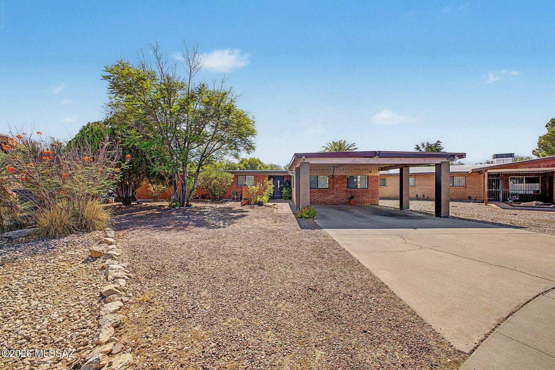 Beautifully updated East Tucson home featuring an open-concept floor plan, modern finishes, and a private backyard retreat. The remodeled kitchen showcases custom cabinetry, granite countertops, stainless steel appliances, a large center island, and abundant storage. Spacious living and dining areas provide plenty of room for entertaining, while the oversized primary suite offers comfort and flexibility. Step outside to enjoy the private swimming pool, covered patio, and low-maintenance desert landscaping. Extended covered parking adds convenience. Ideally located near shopping, dining, parks, schools, golf courses, Trail Dust Town, Park Place Mall, Udall Park, and popular hiking and biking destinations. No HOA and move-in ready!
