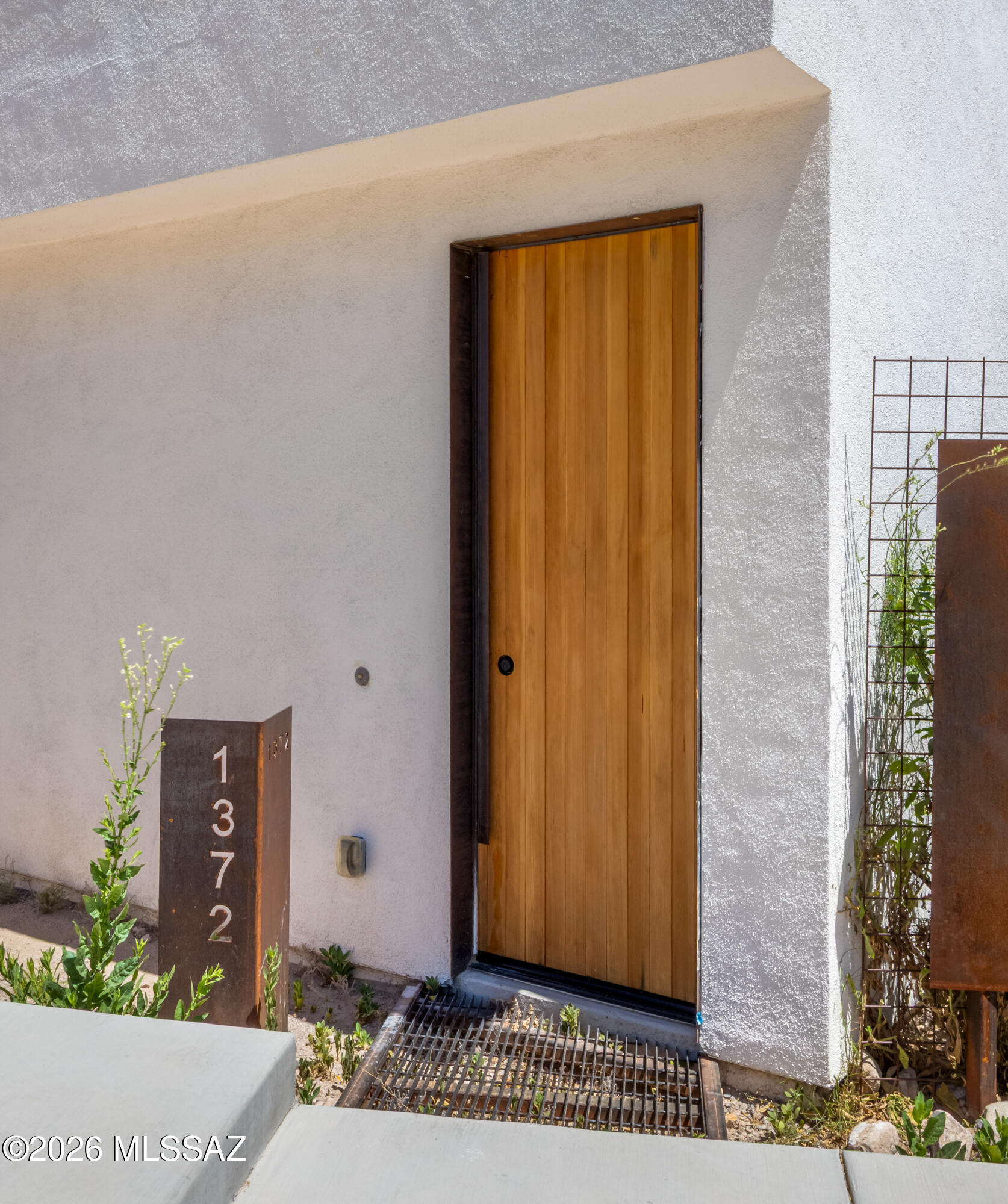 Imagine living at the base of one of Tucson's most iconic landmarks - A Mountain offers a location unlike any other. Architecturally striking and thoughtfully designed, this modern 3 bedroom, 2.5 bath home with loft offers the perfect blend of style, comfort, and easy living. Abundant natural lighting, polished concrete floors, floating wood staircase, and warm natural finishes create a sophisticated urban-desert aesthetic. The open-concept kitchen and living spaces are ideal for entertaining, while the spacious primary suite delivers a spa-like retreat. Ideal for buyers looking to simplify without compromising style, location, or quality. Conveniently located near the vibrant Downtown & Mercado Districts, UA, PCC, hiking trails, golf, entertainment, healthcare & Starr Pass Marriott Resort