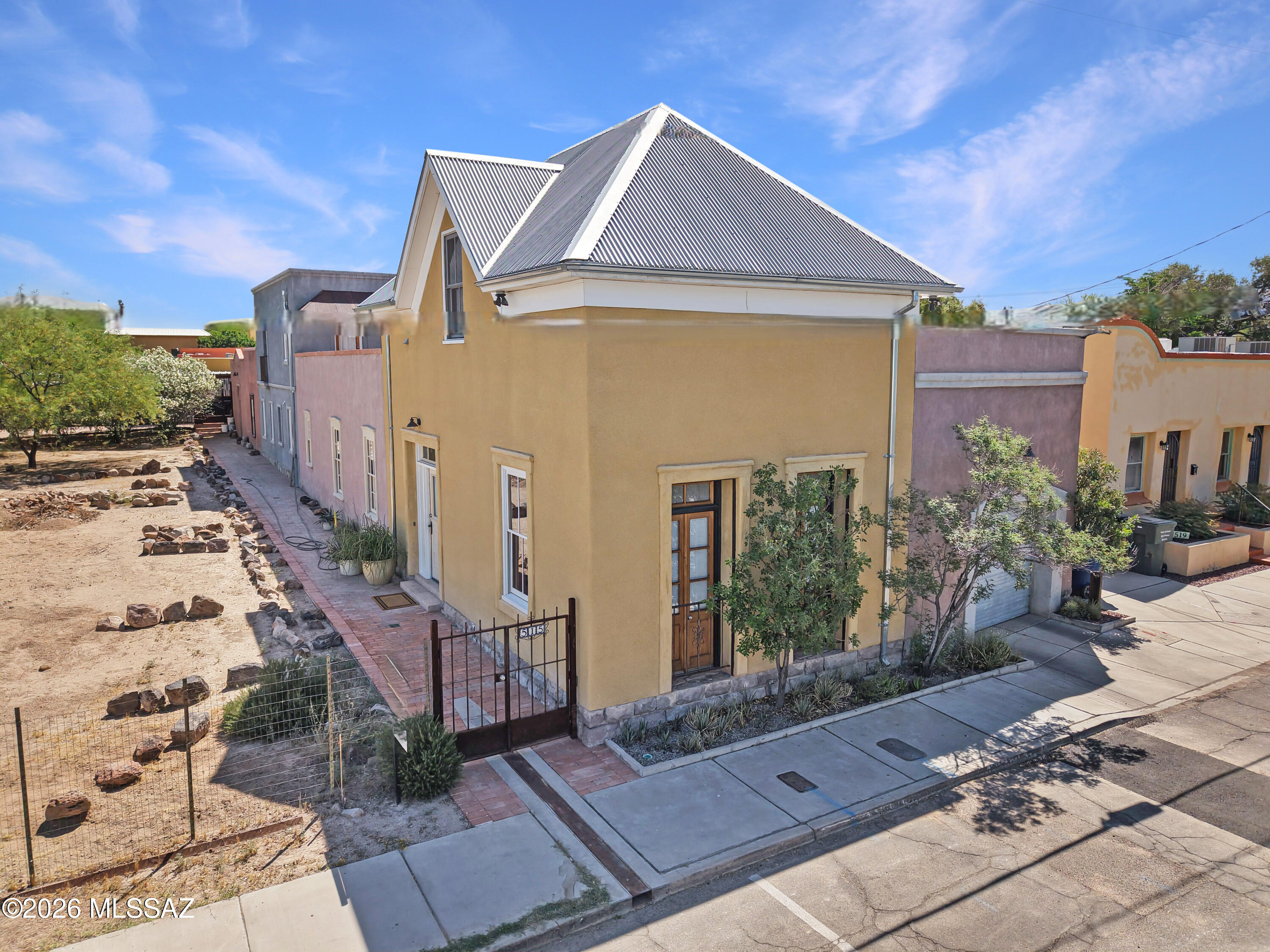 Stunning luxury living in Tucson's oldest barrio!  Gorgeous spacious Barrio Libre home by the barrio's master builder, David Carter, for their own personal residence.  Mikey block construction, looks and feels like adobe, even better insulating qualities. Finished with many historic materials (from local churches, Mt Lemmon trees harvested after the fire, saguaro ribs from our desert). Two stories and three bedrooms with full baths, each en suite. Downstairs primary suite features hand-laid brick domed ceiling. Lush, ultra-private courtyards with fruit trees, a rooftop deck connecting upper bedrooms. A rare treasure property feels 125 years old, yet has none of the restoration concerns of most Barrio Viejo homes.  David Carter pays ultimate homage to the history of his neighborhood.