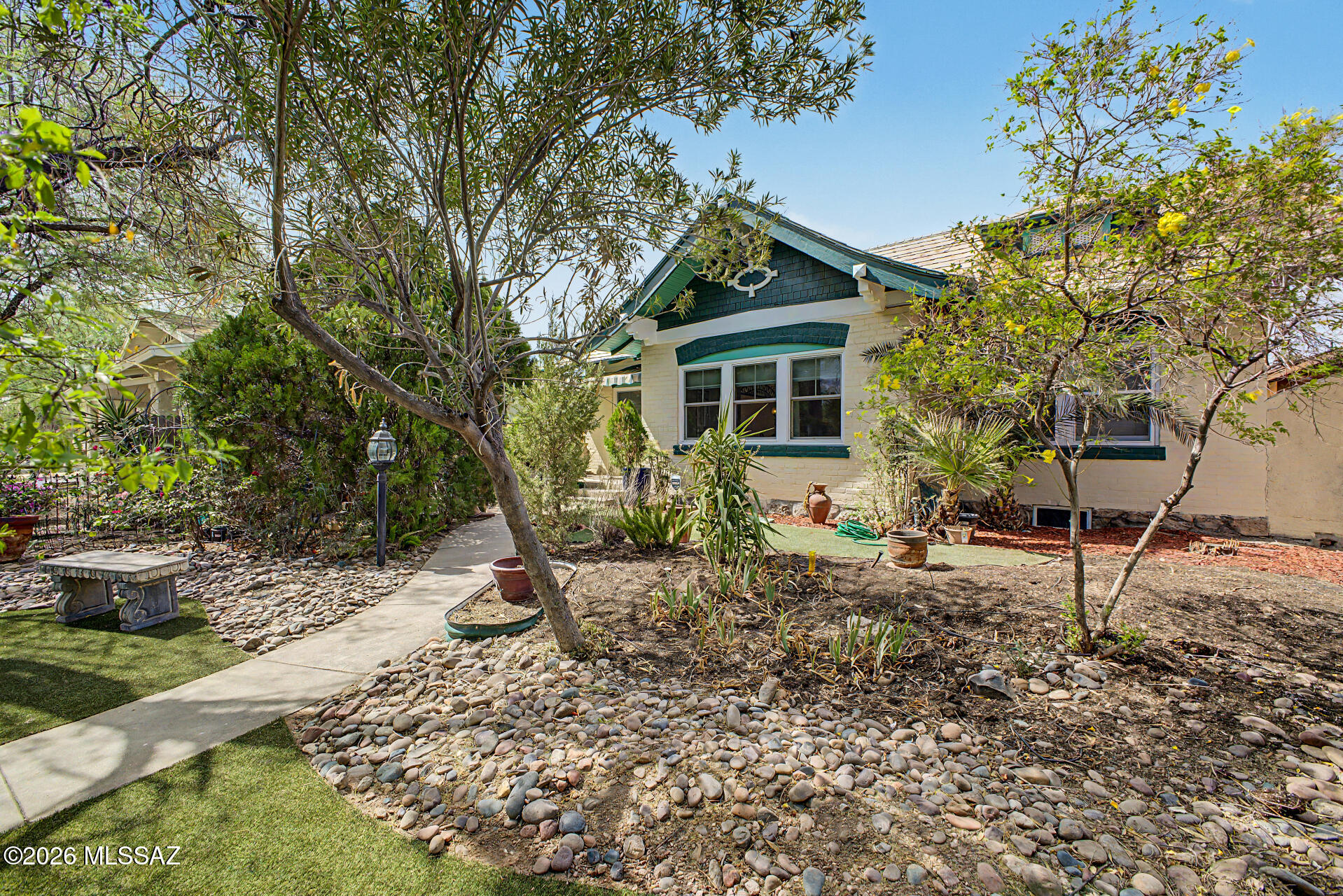 Fall in love with this classic home built in 1905! A true one of a kind home with beautiful original features and tastefully done upgrades.  Enjoy the wood floors, 2 beautiful crystal chandeliers, fully remodeled kitchen with newer appliances, Marmoleum flooring wall to wall and Tiffany pendant lights made by Quizel. Master bathroom is completely remodeled with Carrera marble floor to ceiling including tub. Marble flooring continues in hallway corridor and adjacent  room to master bedroom. The classic and new is combined in the other full bathroom also completely remodeled with black Italian porcelain tiles. Original house tile remains on the sink wall. The HVAC system, installed in 2023 by Hamstra Heating and Cooling, has been regularly maintained. The maintenance contract lasts through January 2027. The front of the main house has five new Marven windows across the living room and dining room. The remaining windows have been serviced and freshly painted. The perfect place for your book collection is in the third bedroom with custom floor to ceiling bookcases and antique chandalier. A gardeners dream. the greenhouse has all electric power, an air cooler, exhaust fan and a dual irrigation system. The floor is a resin material and will last "forever". The front sidewalk pole lights are on an auto light controlled electric eye and light up from dusk until dawn. Park your car out of the sun in the garage and use the workshop for hobbies, extra storage or home office. There is a solar powered back gate to let you in and out of the yard. In the back yard you'll have a serene landscape that makes it easy to relax and enjoy your morning brew on the paver patio, and plenty of space for added storage with sheds. Hurry up, this gem won't last!
