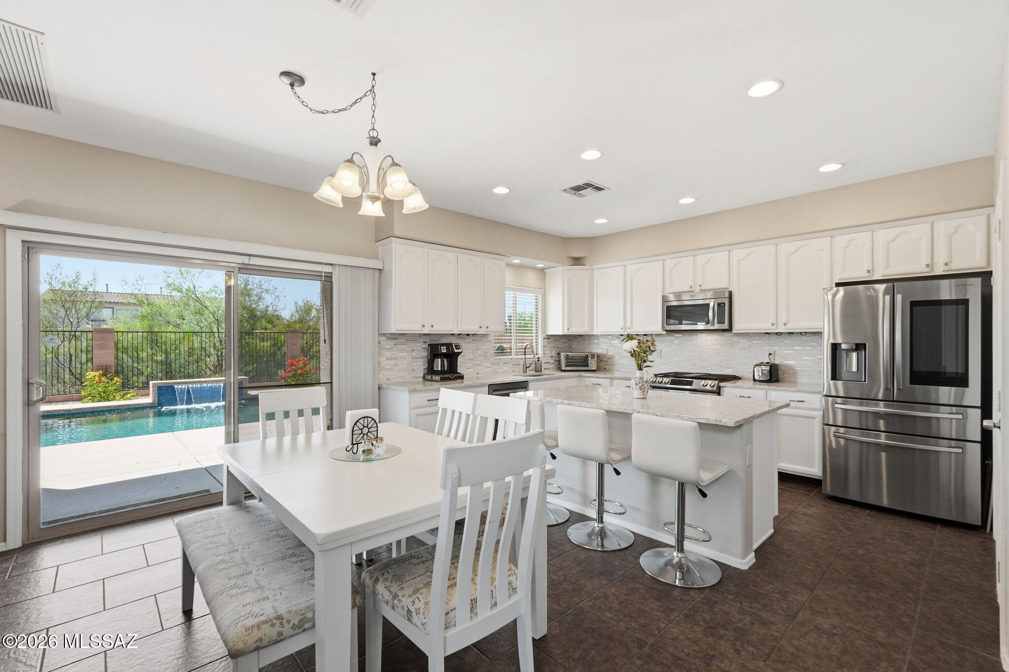 Welcome to your dream home tucked away on a quiet cul-de-sac street. Perfectly positioned in the heart of Oro Valley, this spacious 3BD/2.5BA (2,541 sqft) contemporary residence blends functional family living with the ultimate Arizona outdoor lifestyle with a spacious pool. Step inside to discover a bright and expansive floor plan featuring quartz kitchen countertops and a warm fireplace in the main living space. The large chef's kitchen is a true highlight, packed with storage solutions including extensive cabinetry equipped with convenient slide-out shelves, a standard pantry, plus a massive second walk-in pantry positioned right off the laundry room for effortless organization. Upstairs, you'll find a flexible, open loft space that can easily serve as a tech center, home office, or media room to suit your family's unique needs. The primary suite is a spacious, private sanctuary boasting its own sliding door exit to a deep, full-length balcony. It is the absolute perfect vantage point to unwind and take in Oro Valley's famous, colorful evening sunsets, sparkling city lights, and dramatic mountain silhouettes. The backyard is an entertainer's absolute dream oasis. Bordering a quiet natural wash for enhanced privacy, the rear yard comes fully equipped with a built-in BBQ station, extensive seating space, and a sparkling PebbleTec pool. Whether you're hosting a weekend get-together or enjoying a quiet morning coffee, this outdoor space delivers the resort-style peace you've been looking for. The garage has a dedicated storage space with a utility sink and 250-volt outlet, perfect for EV chargers. With a new roof in 2024, fresh interior and exterior paint, you won't want to miss your opportunity to check out this updated gem!  Just minutes from award-winning schools, multi-use walking paths, local parks, and shopping, this home offers convenience and tranquility in one perfect package.