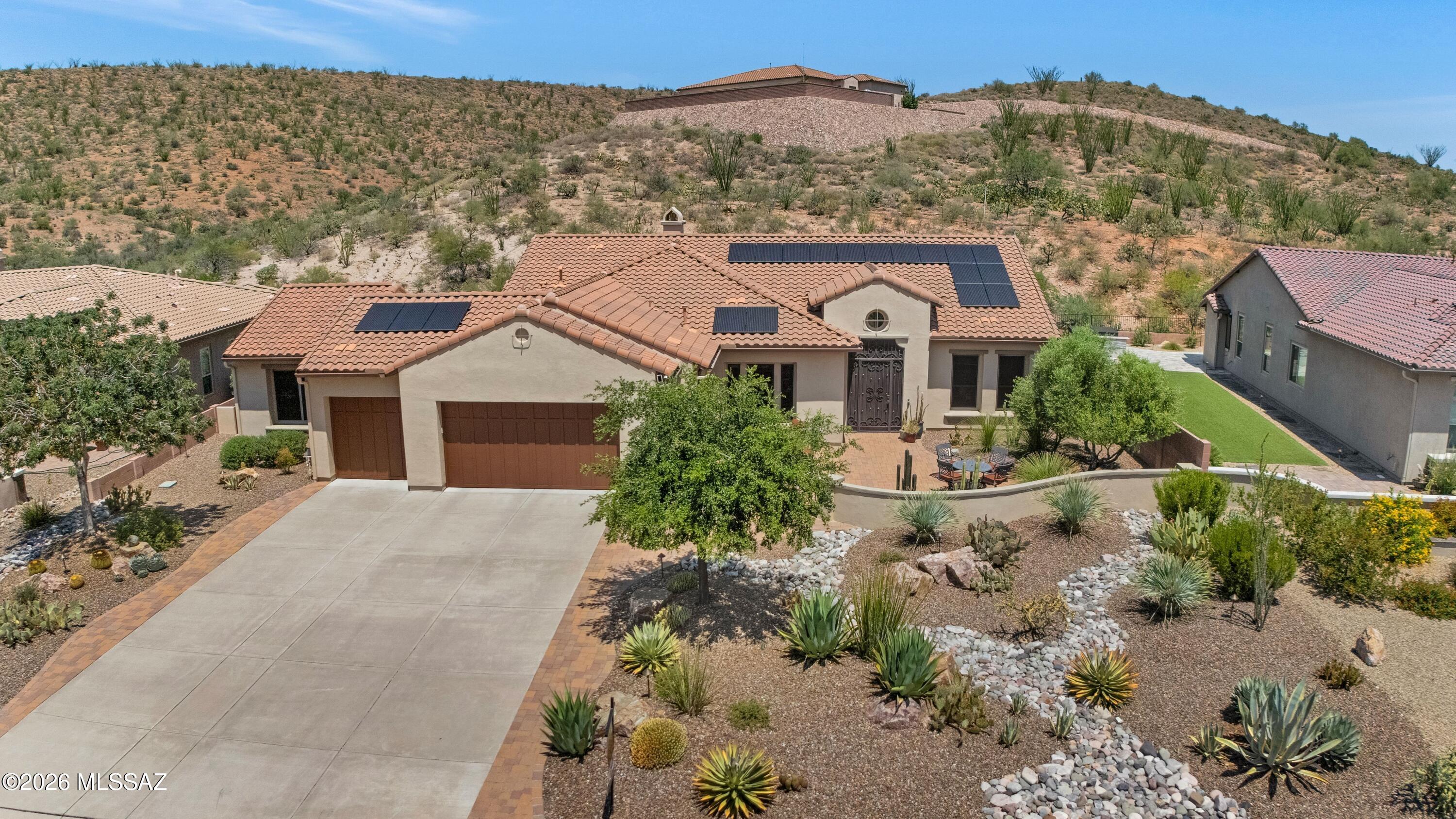 Located in The Preserve, this energy-efficient Sabino with owned Solar! Solar Savings up to $3,600 per year! Curb appeal begins with welcoming front courtyard featuring a cactus fountain & mountain views. Inside, den/office offers private workspace. Great Room showcases a stacked stone media wall with TV, gas fireplace & patio slider for seamless indoor-outdoor living. The Kitchen offers granite counters, stainless steel appliances, induction cooktop, R/O system, center island, & 42'' cabinetry with convenient slide-outs. Powder room & versatile bonus/flex/craft room with slider. Owner's Suite features bay window, patio access, with ensuite bath with soaking tub, walk-in shower, & custom-organized walk-in closet. Guest bedroom with bay window, patio access, closet, & ensuite bath. Laundry room with washer, dryer, & abundant cabinetry. Extended 3-car garage offers built-in cabinets, utility sink, 2 heat pump HVAC's & heat pump W/H. Relax on the covered paver patio with four electric rolling shades while enjoying the privacy of the gated yard & peaceful natural desert setting beyond.