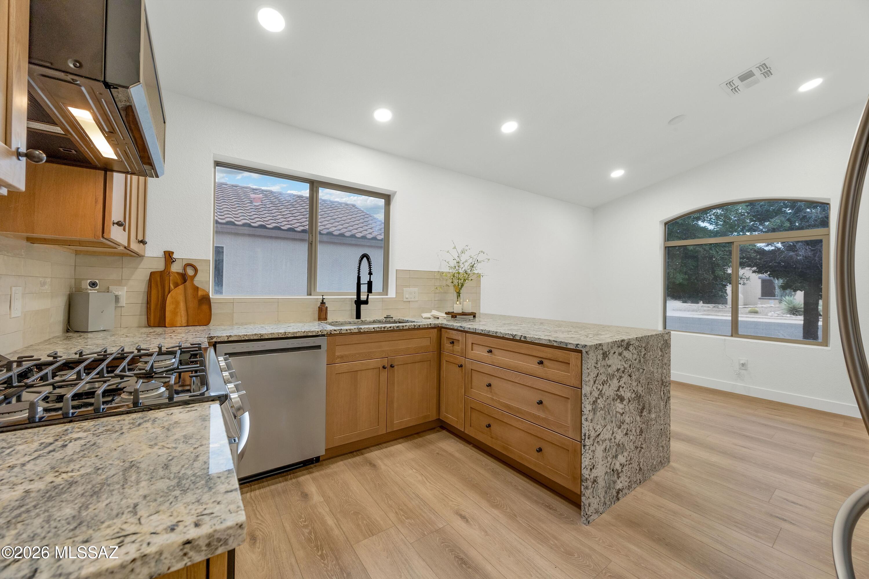 Fully remodeled & move-in ready home in Continental Ranch! This beautifully updated 3 bedroom, 2 bath home offers 1,575 sq ft of thoughtfully designed living space with modern finishes throughout. Enjoy all new flooring, fresh interior paint, updated baseboards, & new LED lighting that creates a bright & inviting atmosphere. The stunning kitchen features a granite slab countertop with a sleek waterfall edge, complemented by brand new appliances including refrigerator, washer, & dryer. Both bathrooms have been tastefully upgraded with new tile, custom tiled showers, & elegant quartz countertops. With quality upgrades from top to bottom, this home blends style, comfort, & functionality in one of Tucson's most sought-after communities. Don't miss your opportunity! Owner Agent