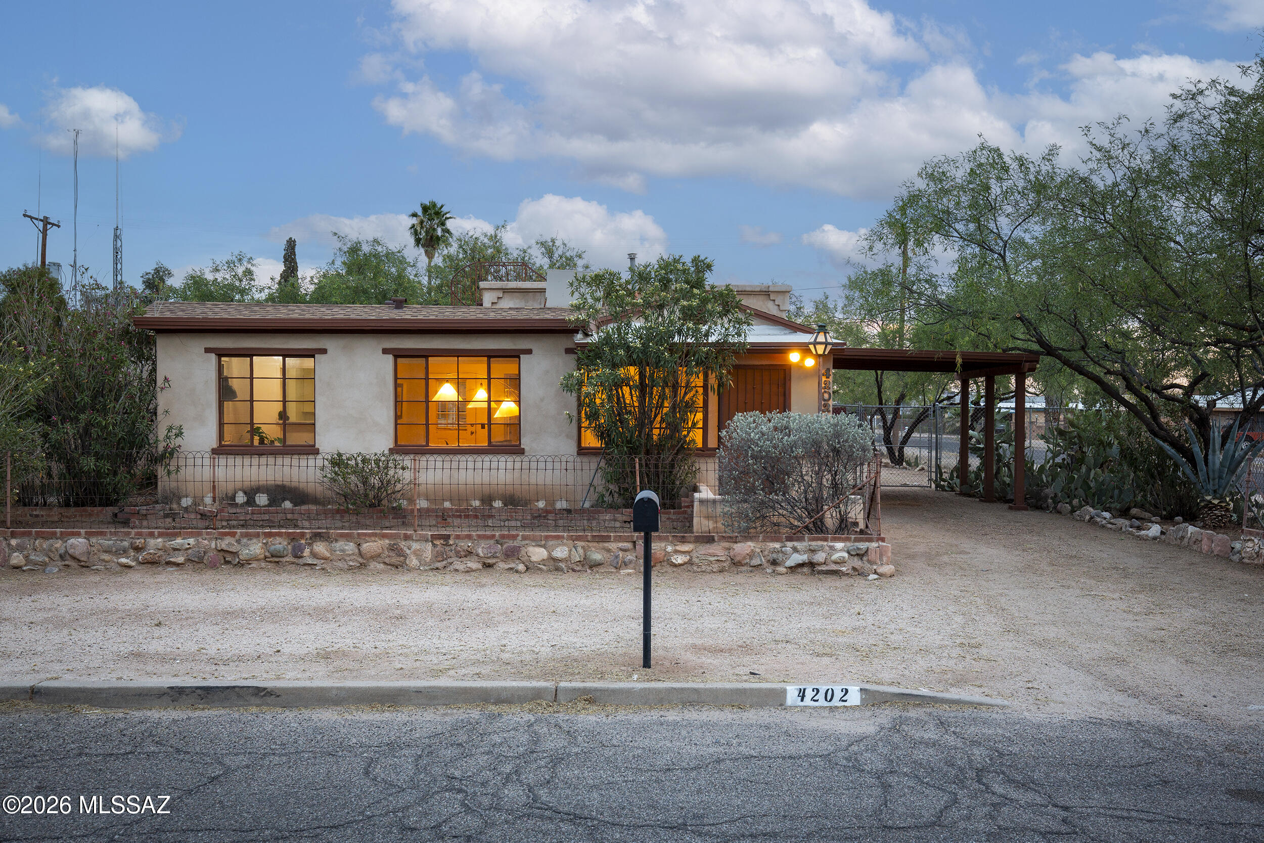 Located in the San Gabriel neighborhood, this charming 1949 bungalow blends original character with a well-balanced floor plan and thoughtful addition. Wood-beamed ceilings and polished concrete floors anchor the main living spaces, with a defined living room that opens into a central dining area, creating a natural flow for everyday living.

The kitchen sits just off the dining room, with direct access to a dedicated laundry/utility room and rear patio, allowing for easy indoor-outdoor connection. The original bedroom and hall bath are set toward the front of the home, while the primary suite addition is privately positioned at the rear. Generous in scale, the primary offers high ceilings, a walk-in closet, and an en-suite bath.

An enclosed entry adds a sense of arrival, while the la corner lot--shaded by mature mesquite trees--provides a spacious yard with room to expand or further enhance outdoor living. Just blocks from Reid Park and close to neighborhood parks, shopping, and schools, the location combines convenience with a strong neighborhood feel.