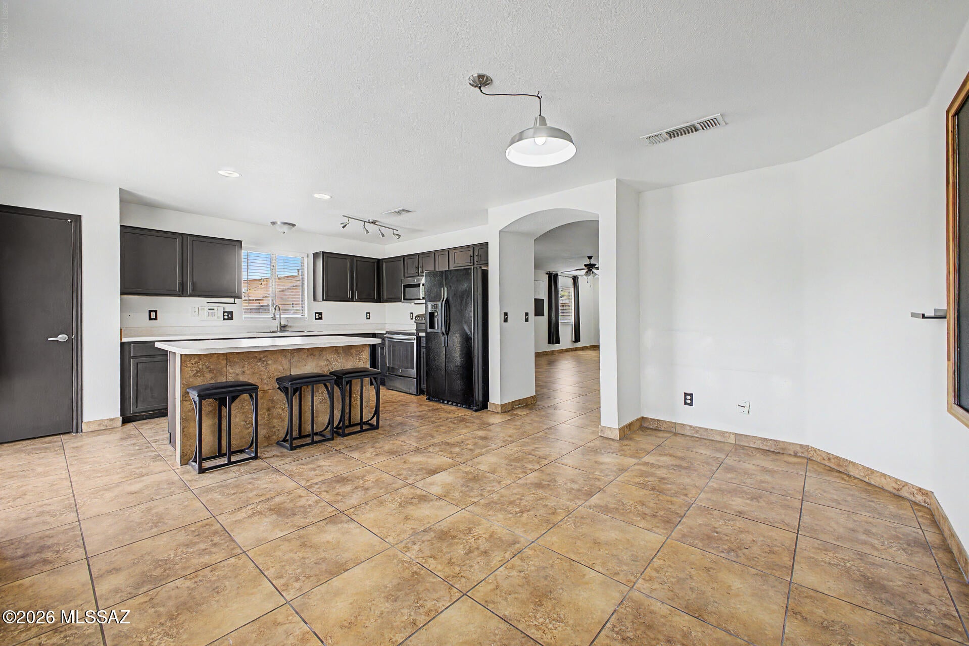 Become the proud owner of this 4-bedroom, 2-bath home on a coveted corner lot! Discover a spacious living room with high ceilings, a contemporary palette, blinds, and durable tile flooring for easy maintenance. The eat-in kitchen comes with ample cabinetry, recessed/track lighting, essential built-in appliances, a pantry, and a center island with a breakfast bar for casual meals. The primary bedroom showcases wood-look flooring, a private bathroom, and a convenient walk-in closet for an organized wardrobe. Converted garage with mini split for added space to become an additonal living room, gym or home office. Unwind at the end of a long day in the backyard, which offers a relaxing spa and abundant space for outdoor get-togethers. Don't miss out on this fantastic opportunity!