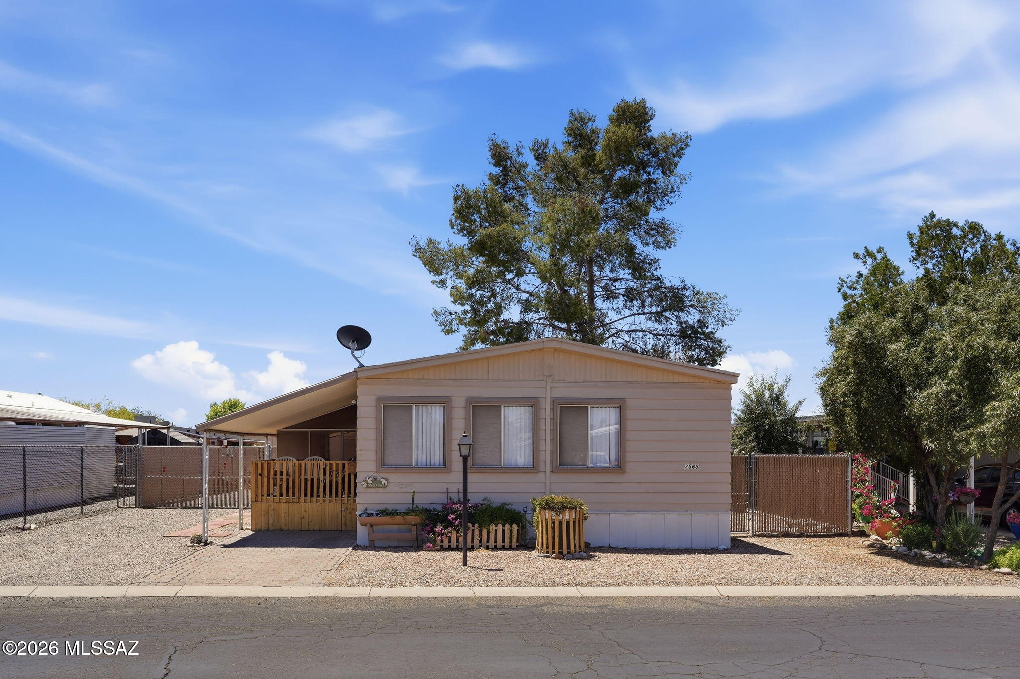 Located in popular Orange Grove Mobile Estates find this 2 bed, 2 bath home. Large living room & dining area w/ built in cabinets & shelves. The kitchen that offers plenty of counter space & cabinets for all of your storage needs is connected to the screened-in porch perfect for morning relaxation. The primary bedroom w/ En Suite provides a separate shower & a garden tub. Pex pipes, laminate floors, ceiling fans, central A/C & full laundry room. Outside, enjoy a spacious lot w/ a carport, front porch, screened-in porch & 2 sheds. The low-cost HOA includes a heated pool, relaxing spa, clubhouse, playground & year-round activities. Close to schools, shopping, dining, medical facilities & access to I-10. Don't miss this opportunity, schedule a private showing. Home qualifies for financing.