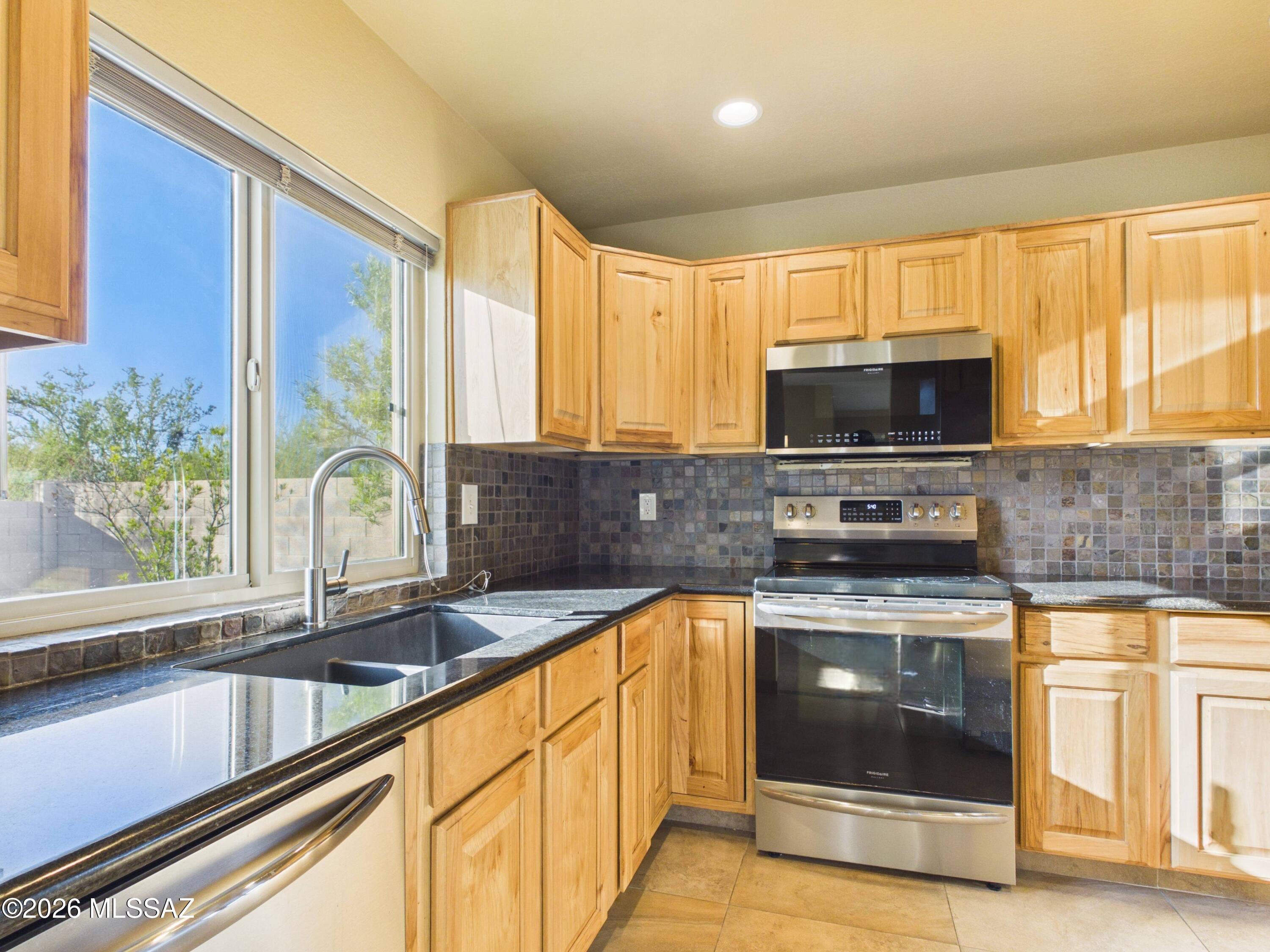 Welcome to this beautifully updated 3-bedroom, 2.5-bath home in the desirable Countryside Vista community. Inside, you'll find an open and inviting floor plan featuring updated flooring, a cozy wood-burning fireplace, and abundant natural light. The kitchen is appointed with granite countertops, stainless steel appliances, custom tile backsplash, and ample cabinetry. Upstairs, the spacious primary suite offers vaulted ceilings, a walk-in closet, dual vanities, and an updated en-suite bath. Step outside to a low-maintenance backyard with a covered patio and built-in BBQ, perfect for entertaining. Complete with a 2-car garage and access to the community pool just down the road.