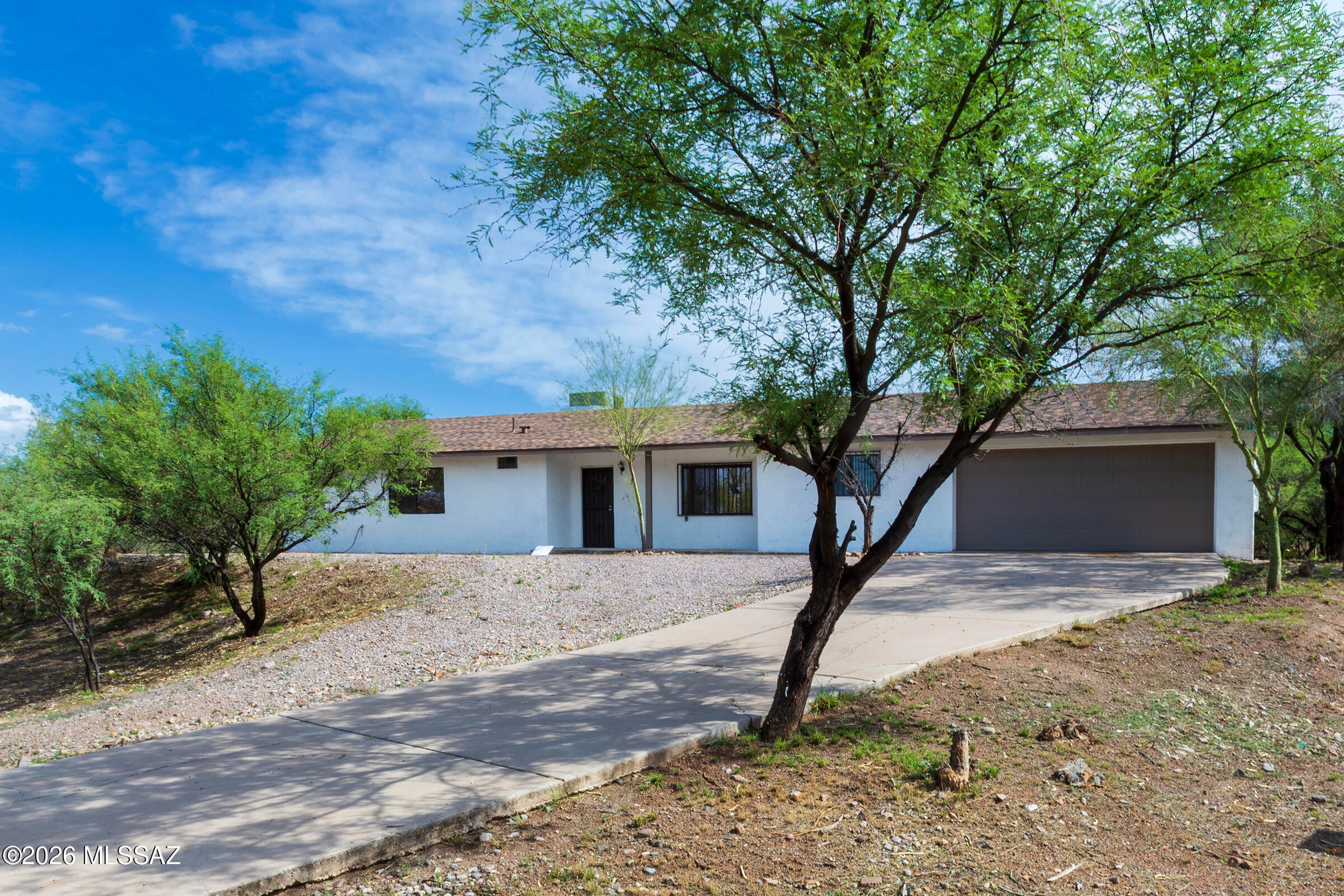 MOVE-IN READY RENTAL! Enjoy beautiful mountain views from this updated home. The interior features tile flooring, granite countertops, vessel sinks, updated fixtures, ceiling fans and stainless steel appliances. The open and inviting layout offers
comfortable living with modern finishes throughout. Outside, enjoy a private fenced backyard with artificial turf, plenty of room to relax and space for outdoor entertaining. Decorative security doors and a sliding wrought iron gate. Conveniently located near I-19 for an easy commute. Pets subject to owner approval.