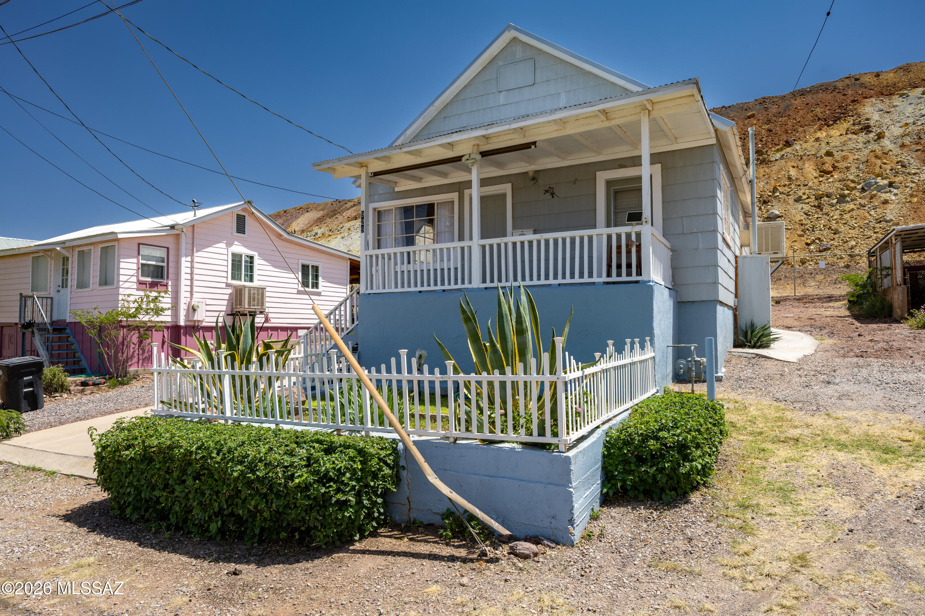 Own a piece of Bisbee history for under $200,000! Built in 1906, this charming 2-bedroom miner's cottage in Bisbee's Bakerville neighborhood offers an affordable opportunity to make Bisbee your full-time home, weekend getaway, or Arizona retreat. With no HOA and the flexibility for short- or long-term rental use, there are plenty of possibilities for how you make this property your own. The 834-square-foot home welcomes you with a covered front porch, classic white picket fence, durable metal roof, and off-street parking, a feature you'll appreciate in Bisbee. Inside, bamboo flooring adds warmth to the kitchen, while the well-maintained bathroom and comfortable living spaces reflect years of pride of ownership. Step outside, settle onto the porch, and take in the surrounding hills and distinctive character of this historic neighborhood. Just minutes from Old Bisbee's shops, restaurants, galleries, entertainment, and year-round events, this little cottage puts the Bisbee lifestyle within reach. Come see what life in Bisbee could look like.