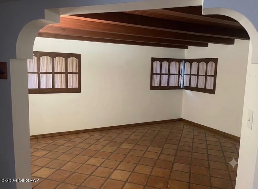 Major ''fix up'' 3BR/1.75Bth. Mid-century modern burnt adobe home w/beamed ceilings tucked beneath the shade of mature trees & a huge saguaro. Conveniently located near shopping, dining, entertainment & TMC.  
Established central neighborhood. No HOA. 
Ensuite bathroom + Jack & Jill bath. Laundry is located in a separate 10'X17' building. (Guest house or workshop potential.)  Yard contains an attractive ramada. 1263 sq. ft. + approx. 200 sq.ft. kitchen addition in 2003. ''As is'' sale.   
''Early Bird'' title report started with Dina De La Ossa, Catalina Title/First American, 520-747-1644, 3777 E. Broadway