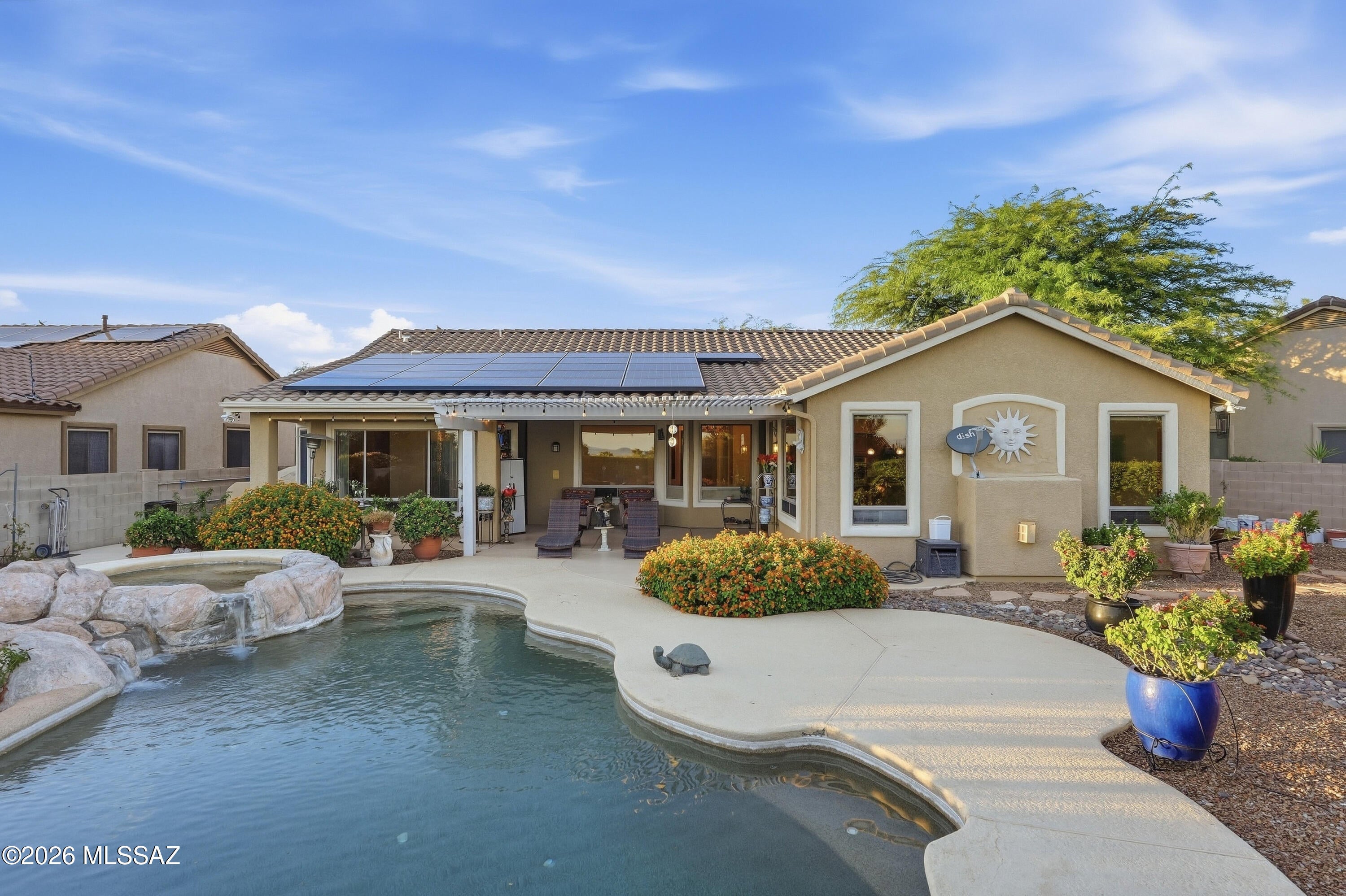 Experience resort-style living in the heart of Oro Valley! This 4BD/2BA home offers 2,441 sq ft, a 3-car garage, split floor plan with newer flooring in 2026. Situated on a spacious .30-acre cul-de-sac lot, the backyard is an Arizona dream with a sparkling pool and spa, cascading waterfall, built-in BBQ, firepit, pergola, covered patio, mature landscaping and beautiful mountain views. The spacious primary suite features a charming bay window with mountain views. Ideally located near shopping, dining, golf, recreation and walking trails. Your private Oro Valley retreat awaits!